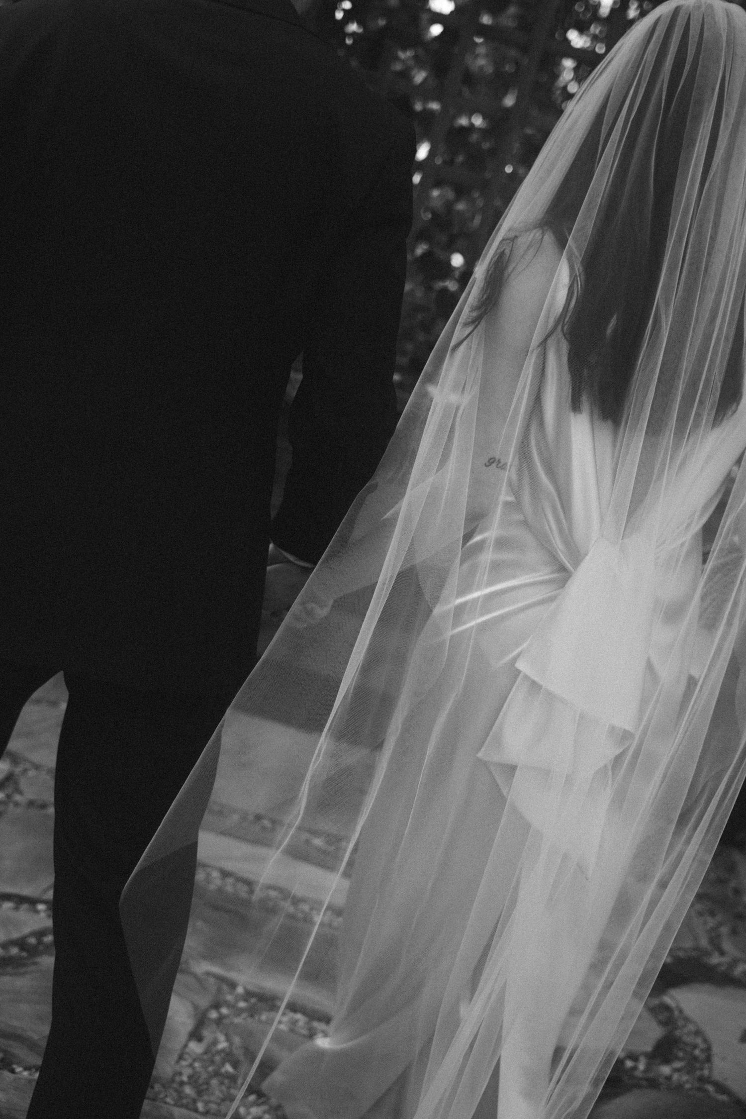 Artistic black and white photos showing flowing wedding veil details in natural light.