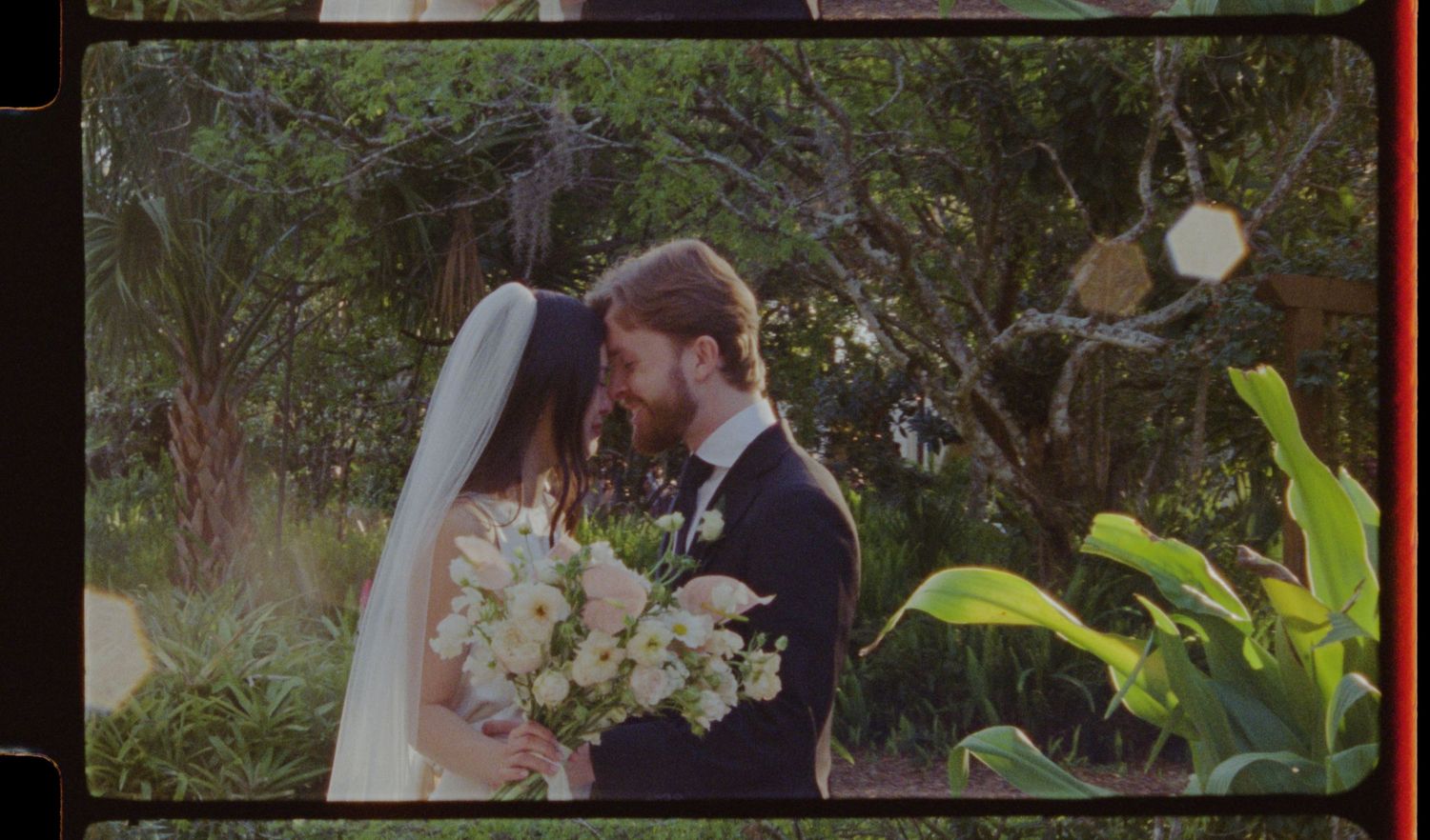 A beautiful garden wedding ceremony with tropical plants and floral arrangements.
