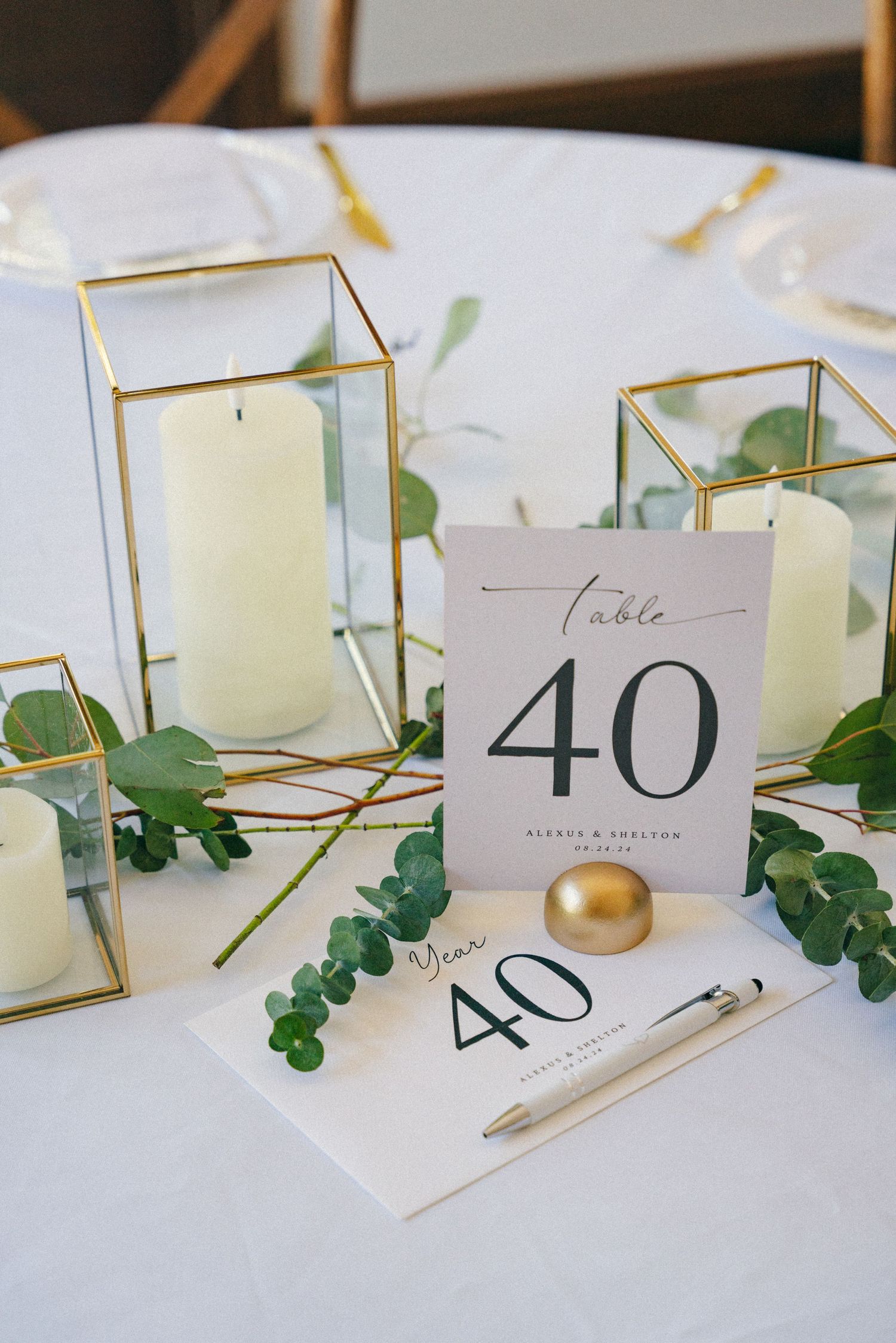 Modern wedding table decor with gold geometric candle holders and table number 40.