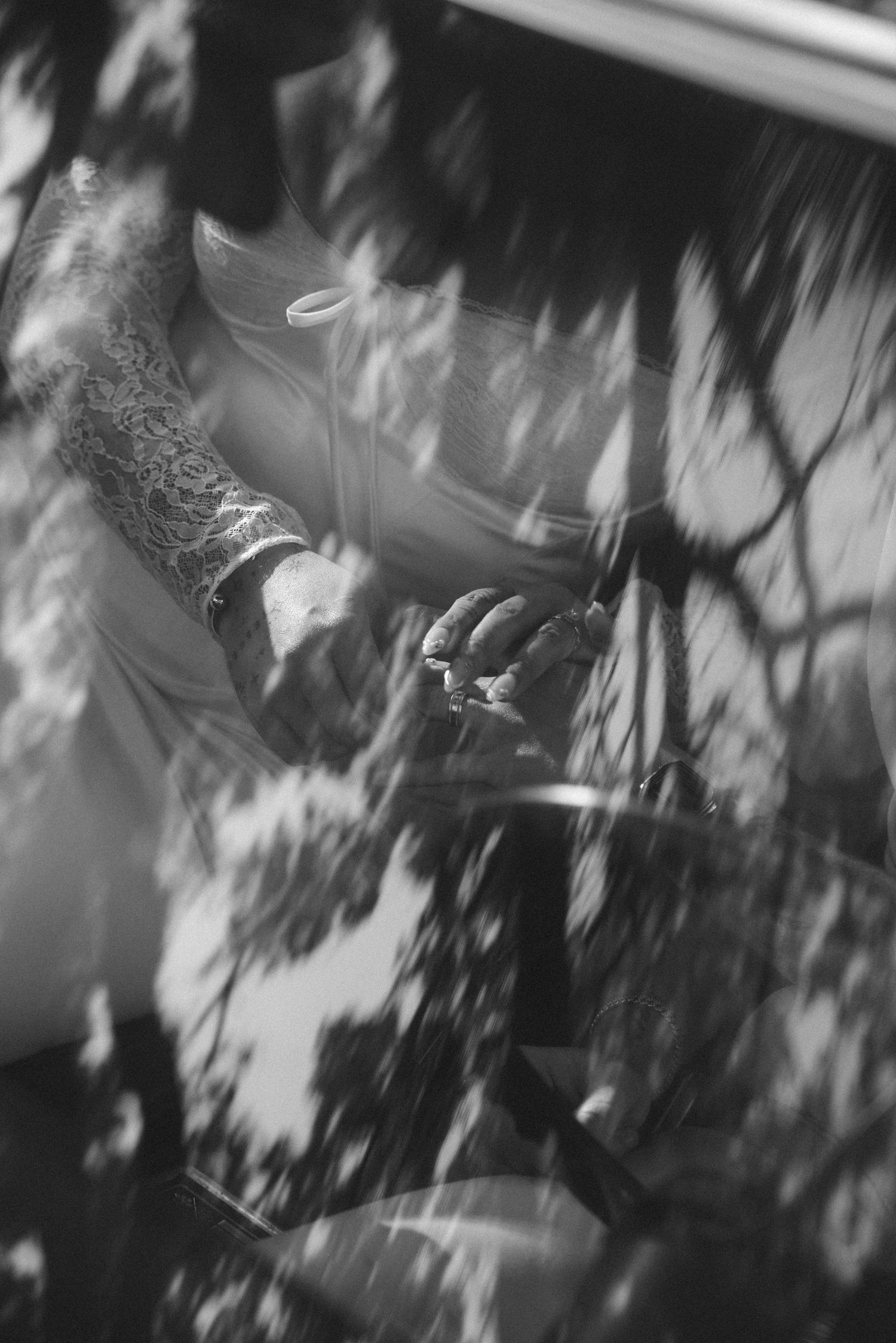 Artistic black and white photo showing dappled light and shadows at an outdoor event.