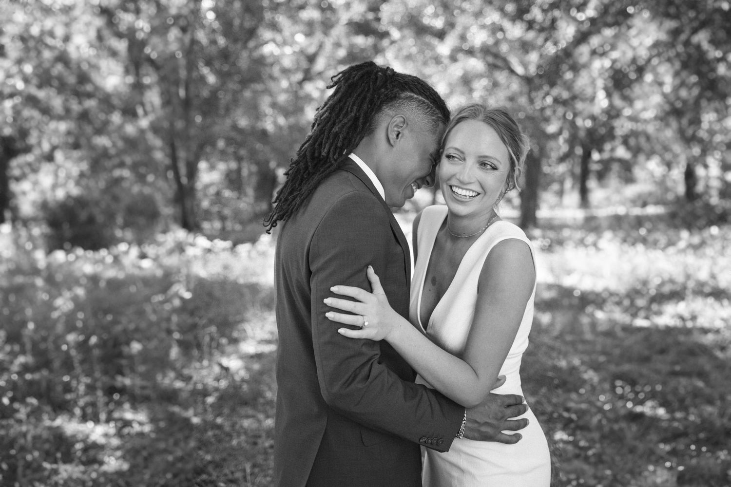 Romantic black and white photo series of a couple sharing tender moments outdoors.