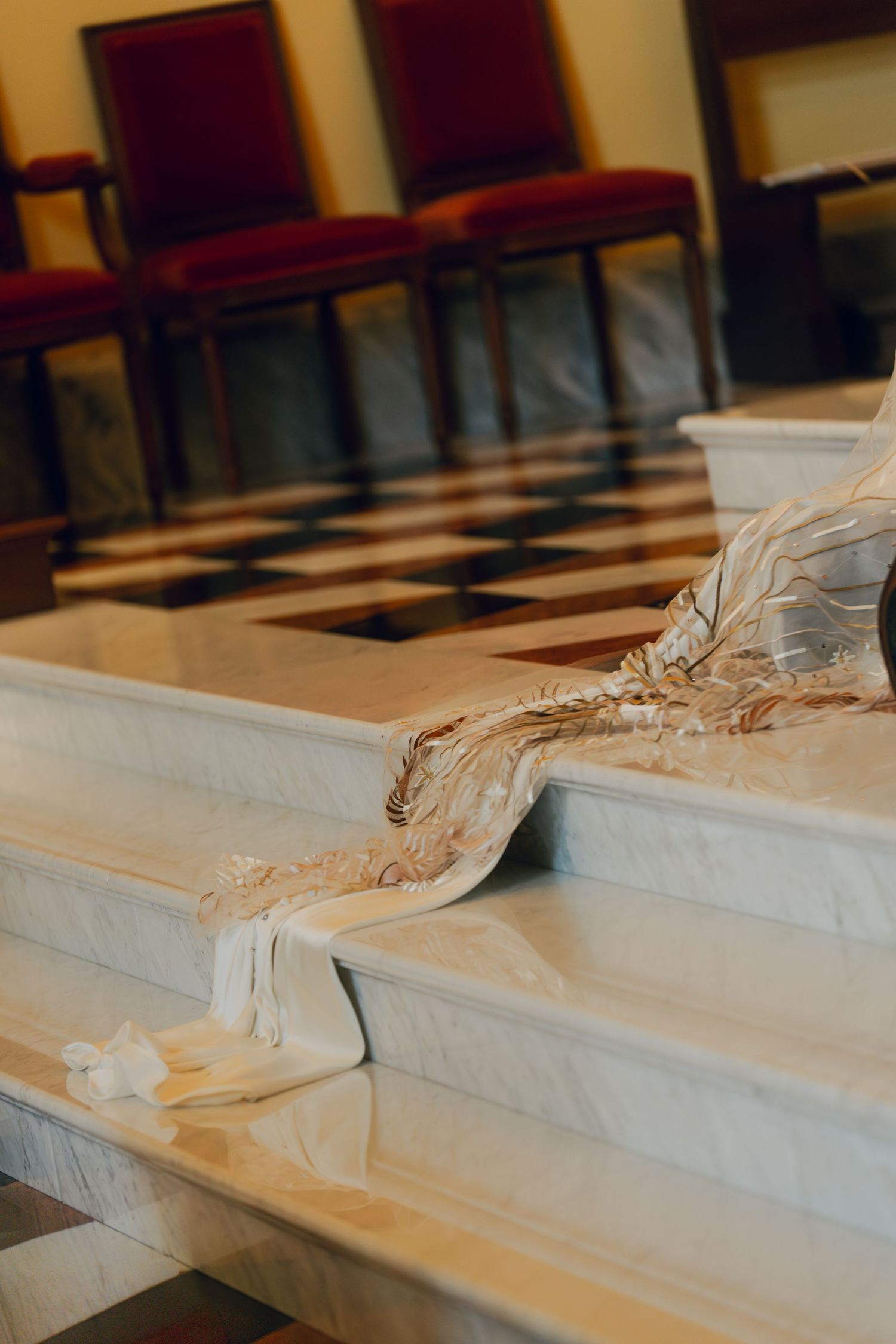 Close-up of white marble church altar steps with ornate architectural details.