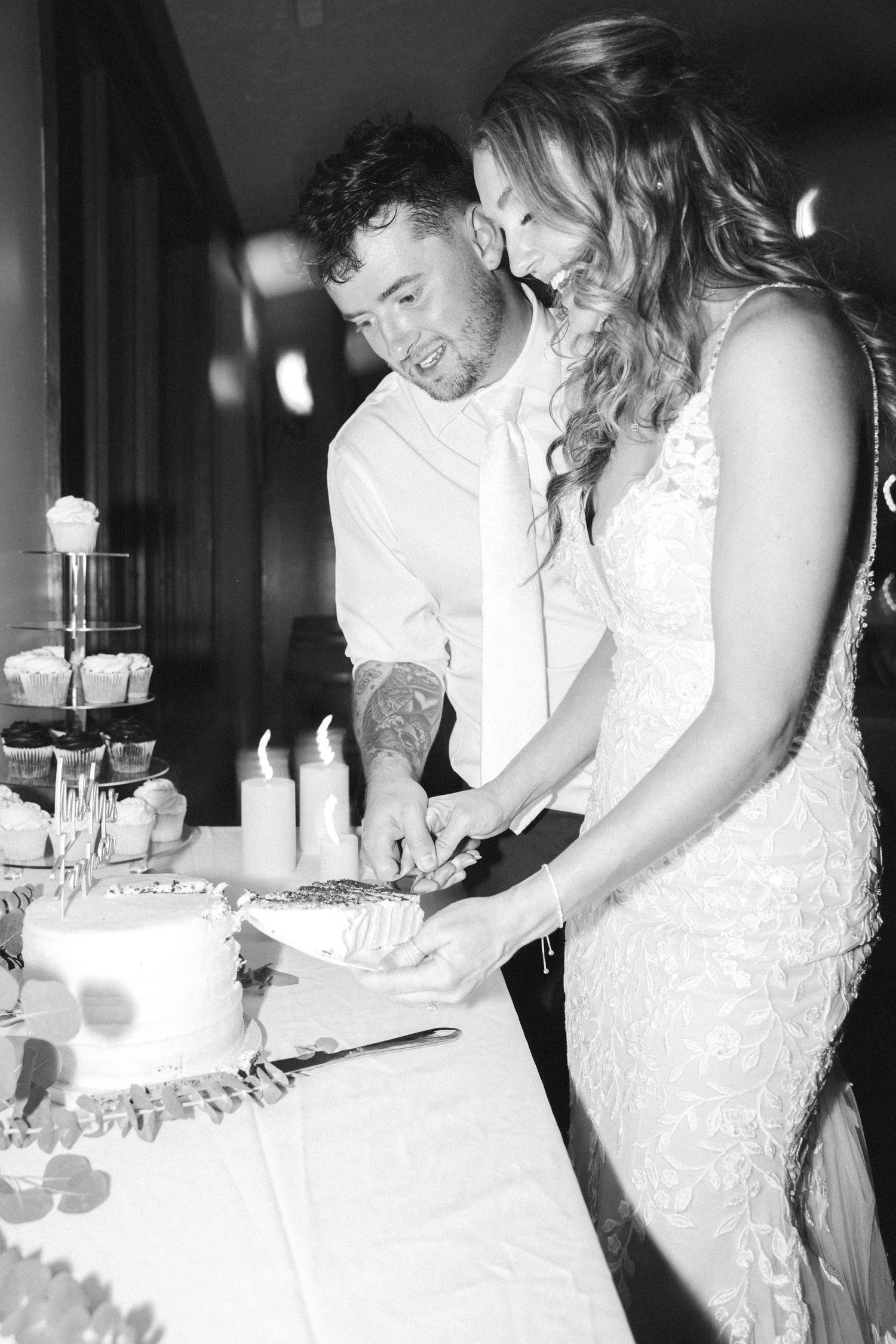 Black and white images of a couple cutting their wedding cake together.