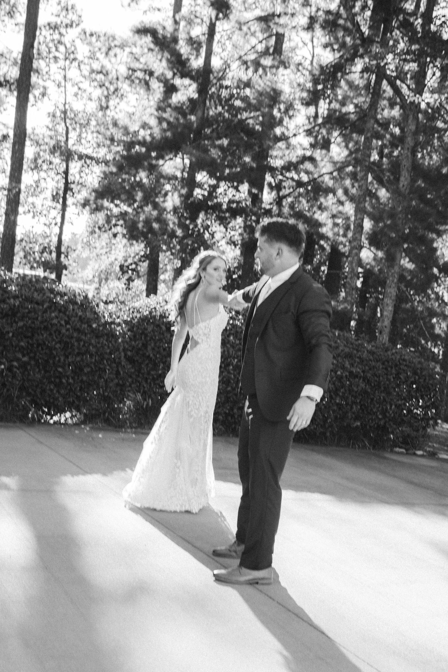 Series of romantic first dance moments captured in black and white on an outdoor dance floor.