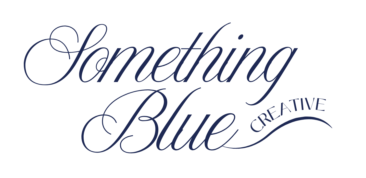 Elegant cursive logo design for 'Something Blue Creative' in navy blue calligraphy on white background.