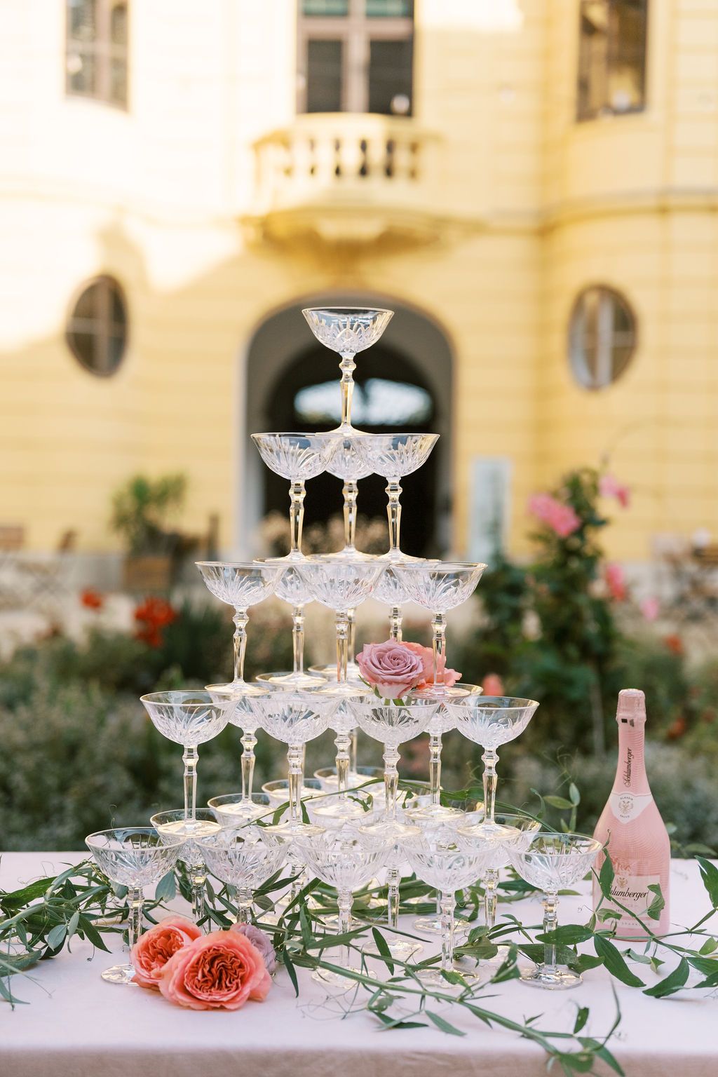 Champagne tower with Schloss Eckartsau Austria palace in background — European destination wedding styled shoot by Helen Fang Studio