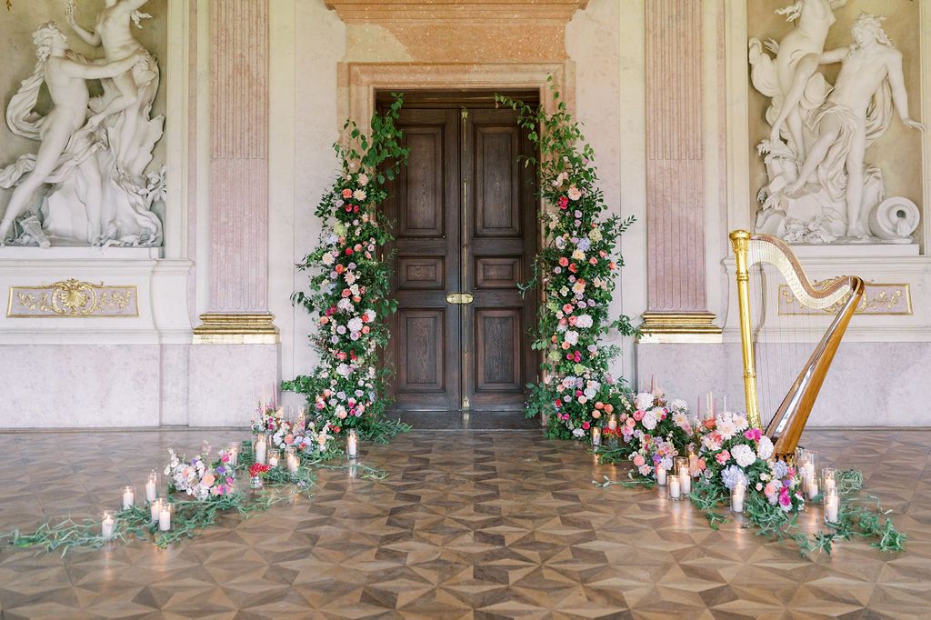 Flower-adorned baroque doorway at Schloss Eckartsau Austria — European destination wedding photography