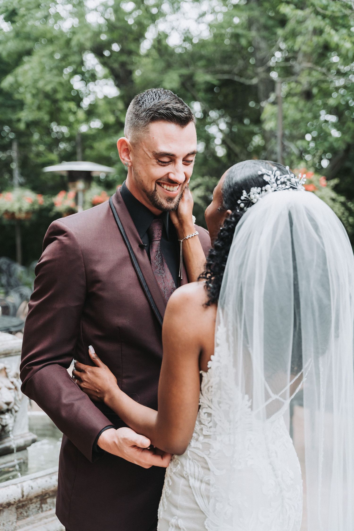 Intimate moment between newlyweds outdoors during wedding celebration.