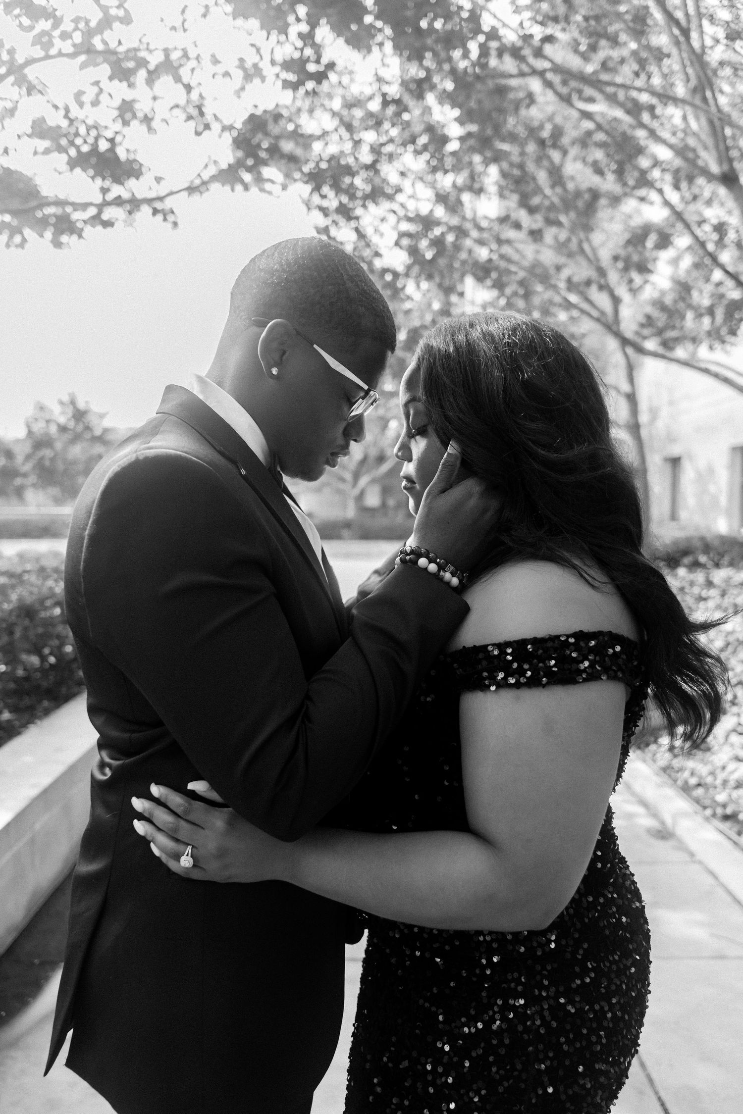 Intimate outdoor portrait of couple in formal attire.