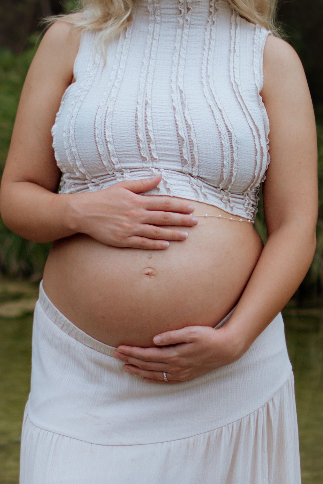 A series of maternity photos showing a growing baby bump in a white dress against an outdoor background.
