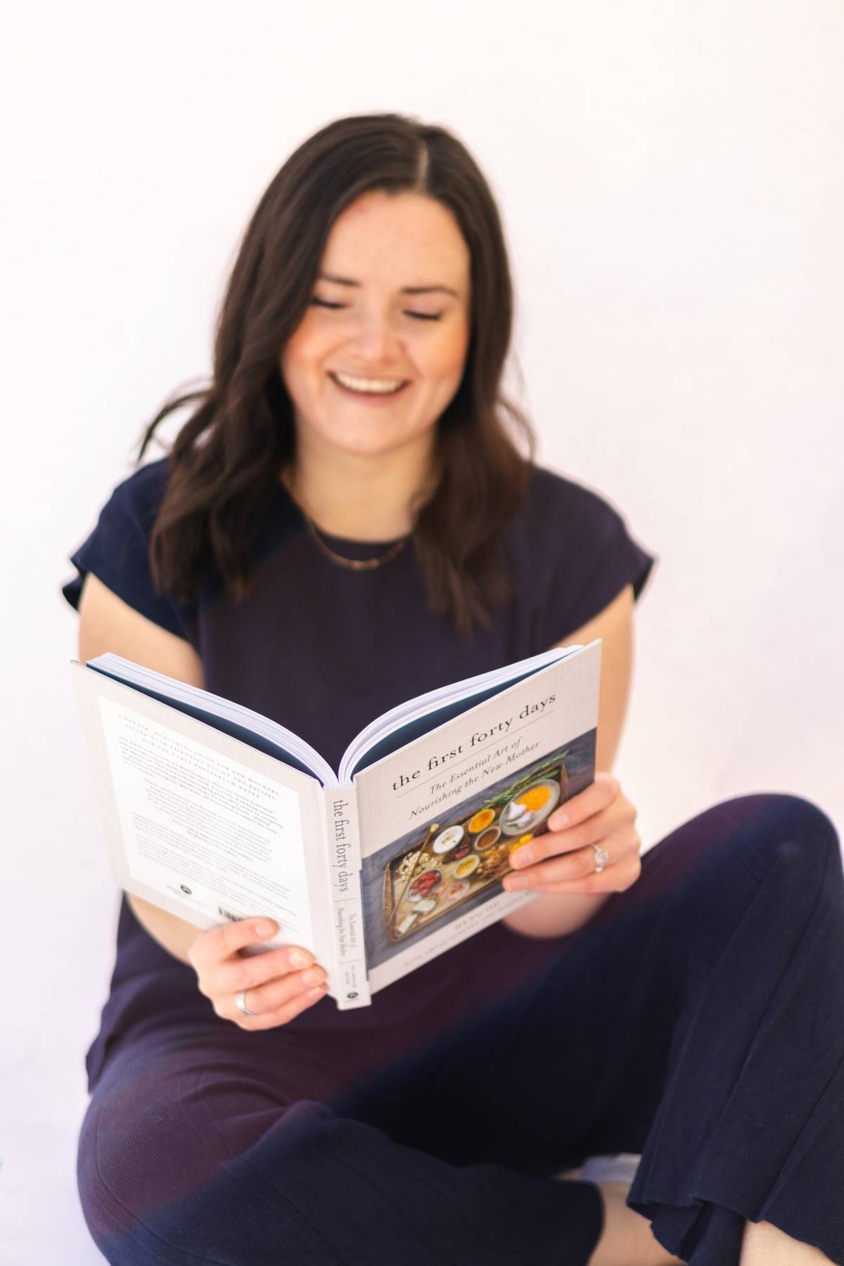 Postpartum doula reading book.