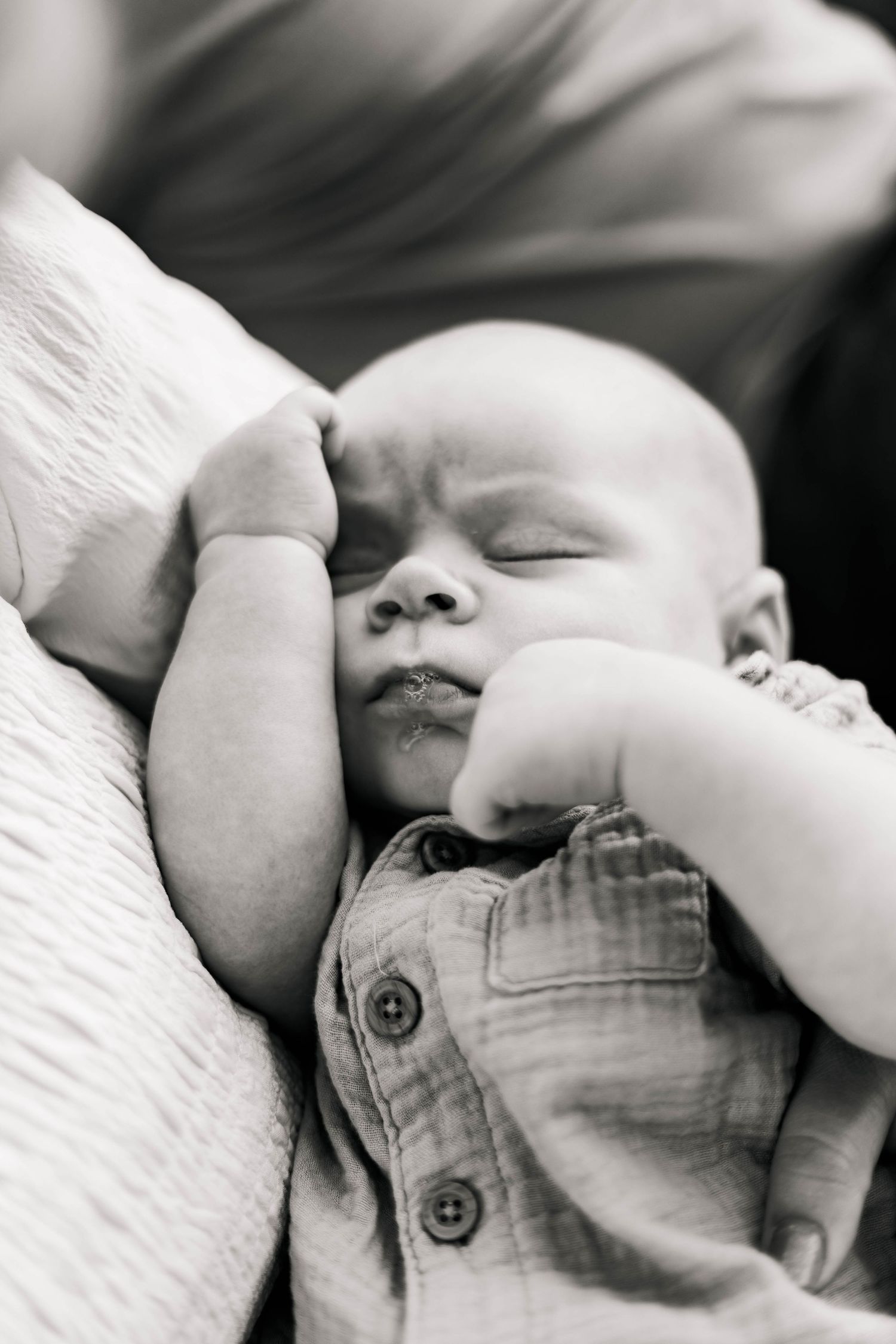A peaceful newborn baby sleeping soundly in black and white photography in Elverson, PA.