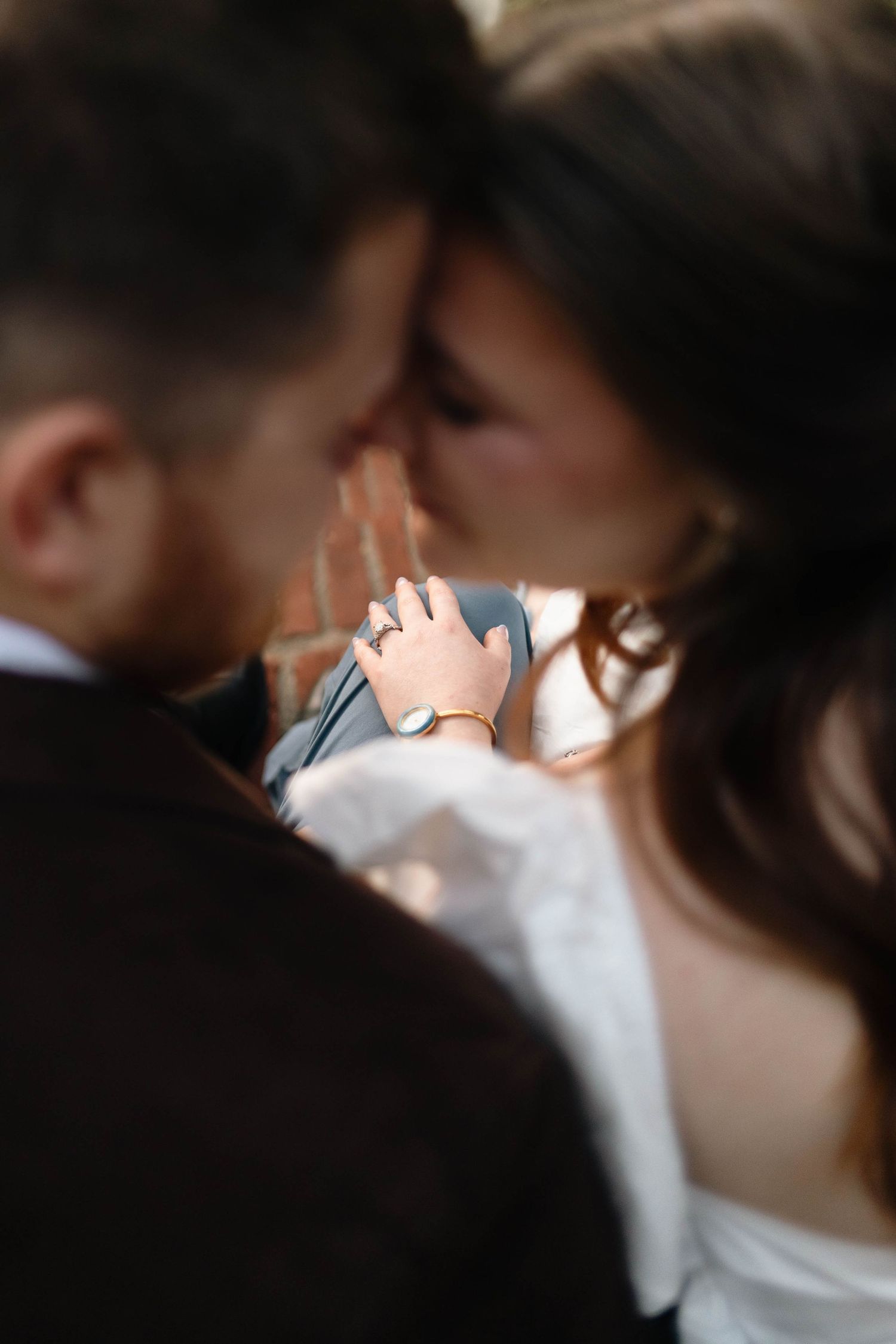 Close-up of couple nearly kissing, woman's hand with ring resting gently on mans chest in West Chester, PA.