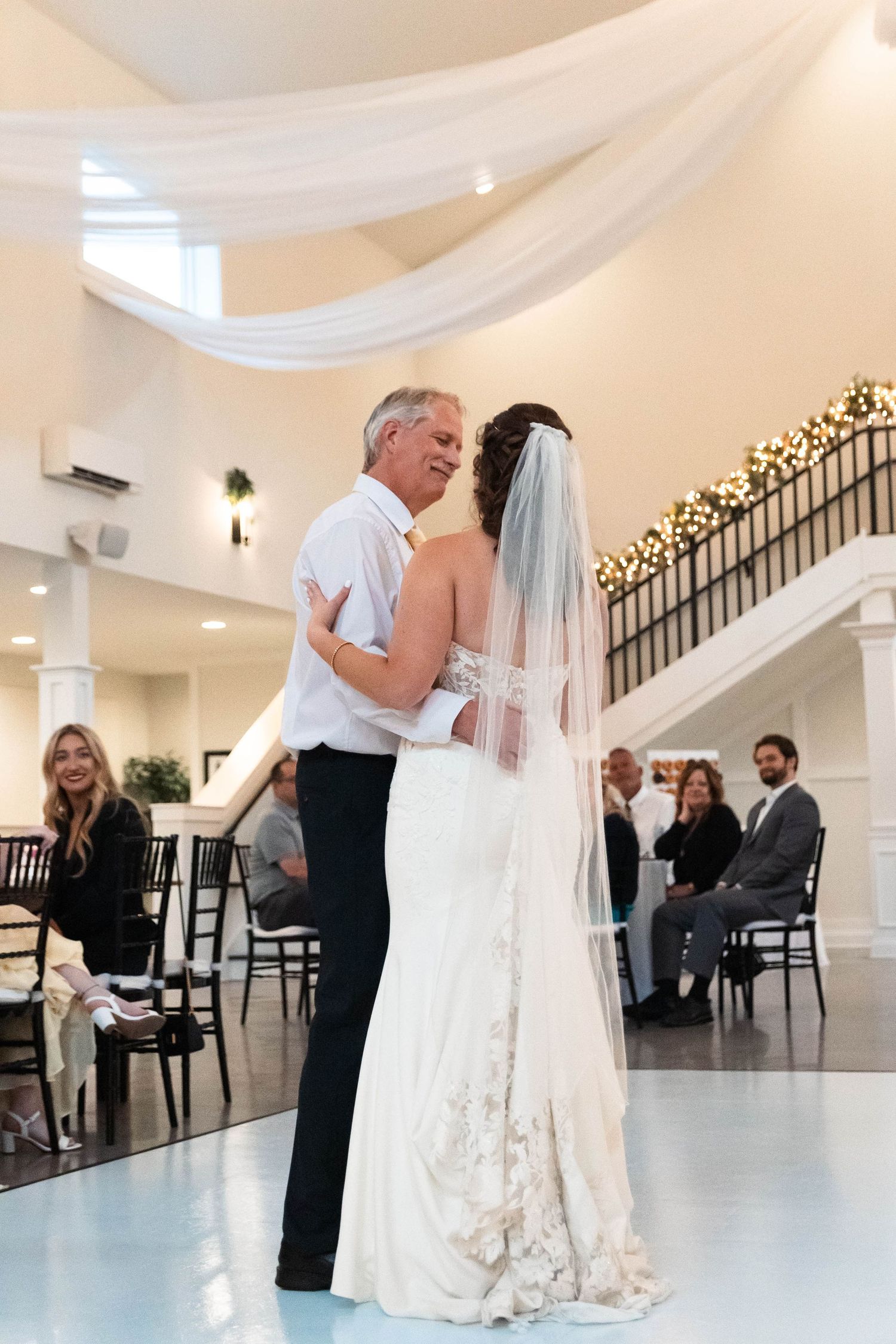 Father daughter first dance at elegant wedding reception venue.