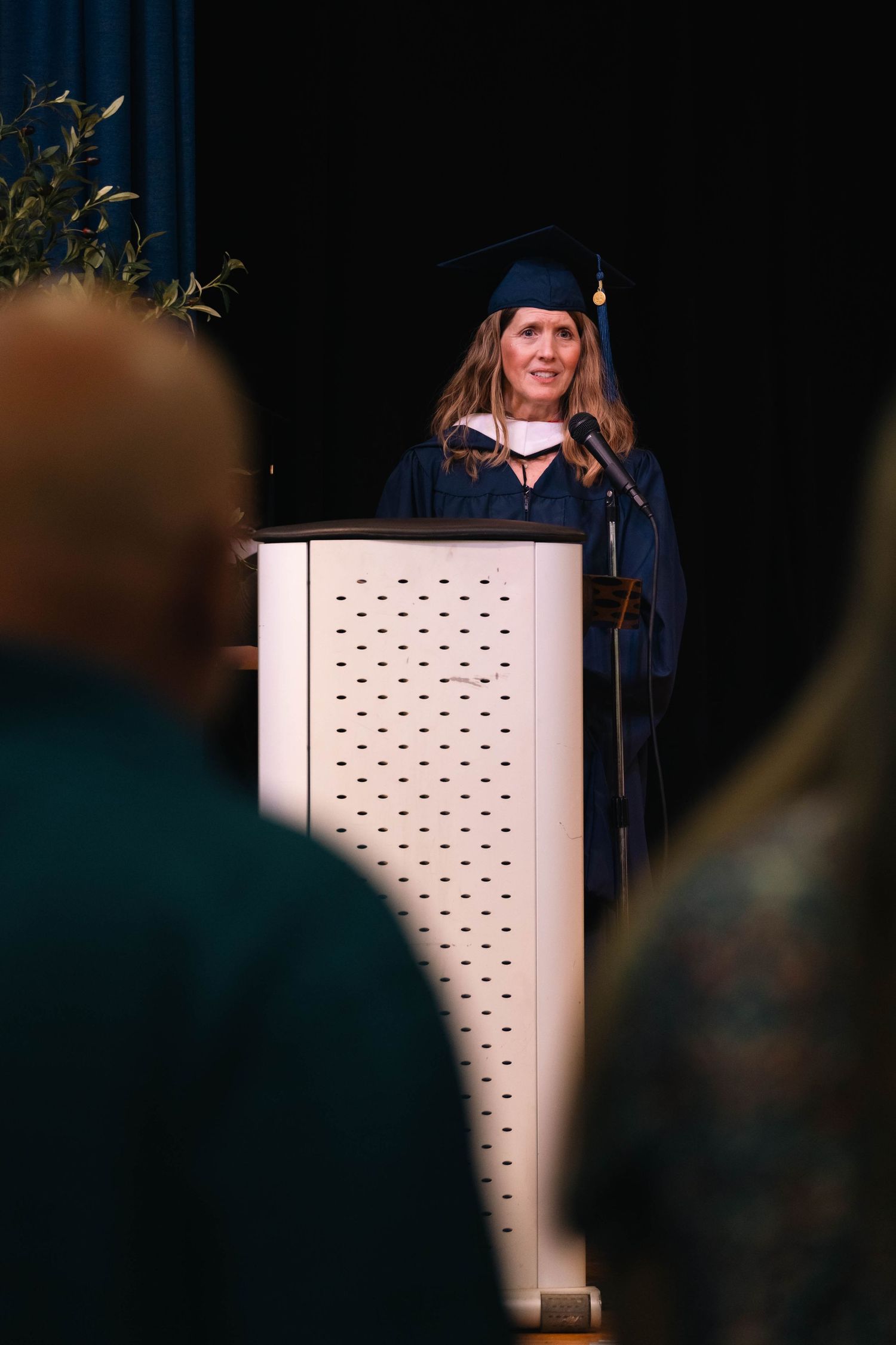 Alliance Christian School Graduation Ceremony wit superintendent delivering speech at white podium during ceremony.