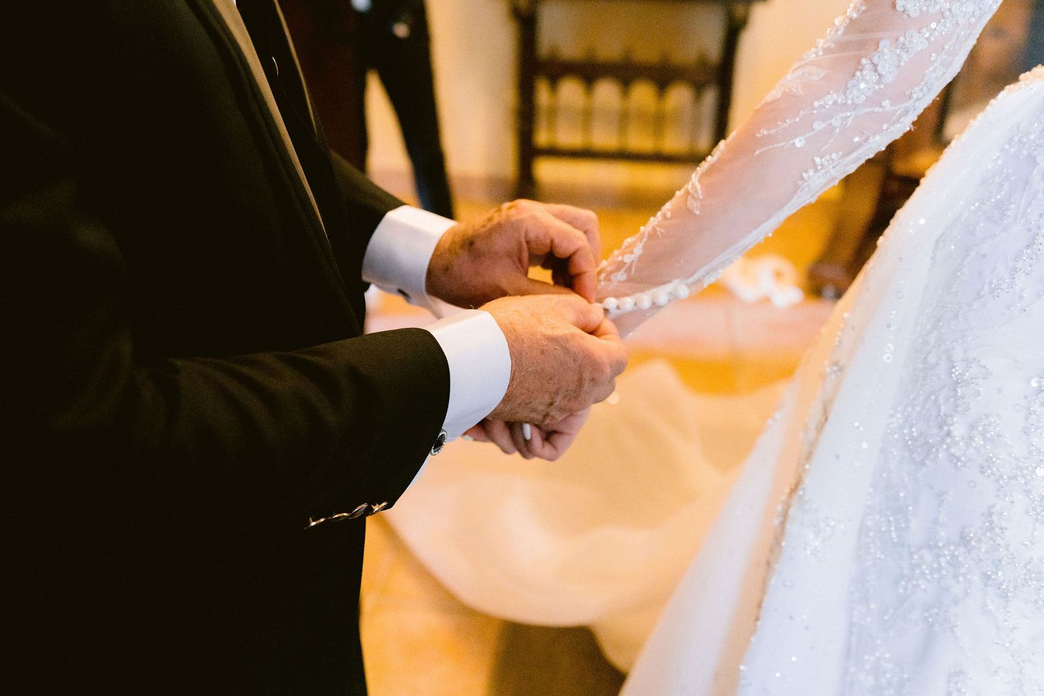 A close-up sequence of someone holding white silk or satin fabric, showing the delicate texture and movement in detail.
