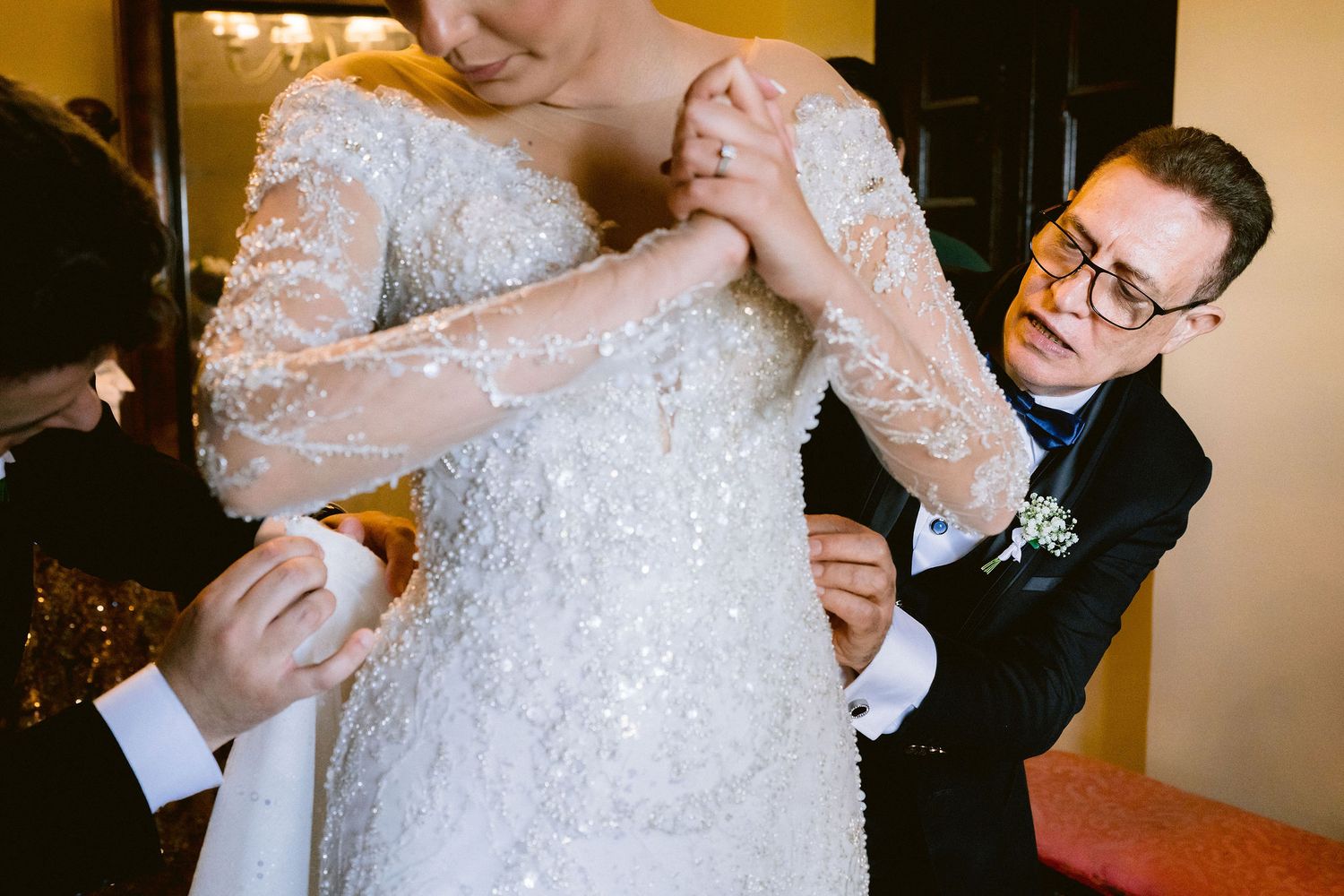 A bride and groom hold champagne glasses in a wedding toast gesture at their reception celebration.