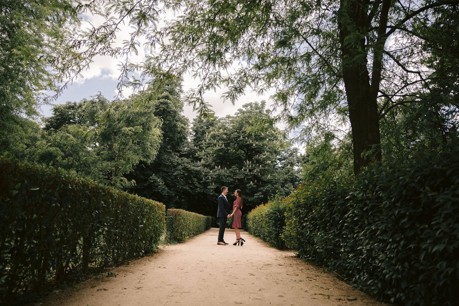 Tree-lined garden pathway creates a romantic setting for special moments.