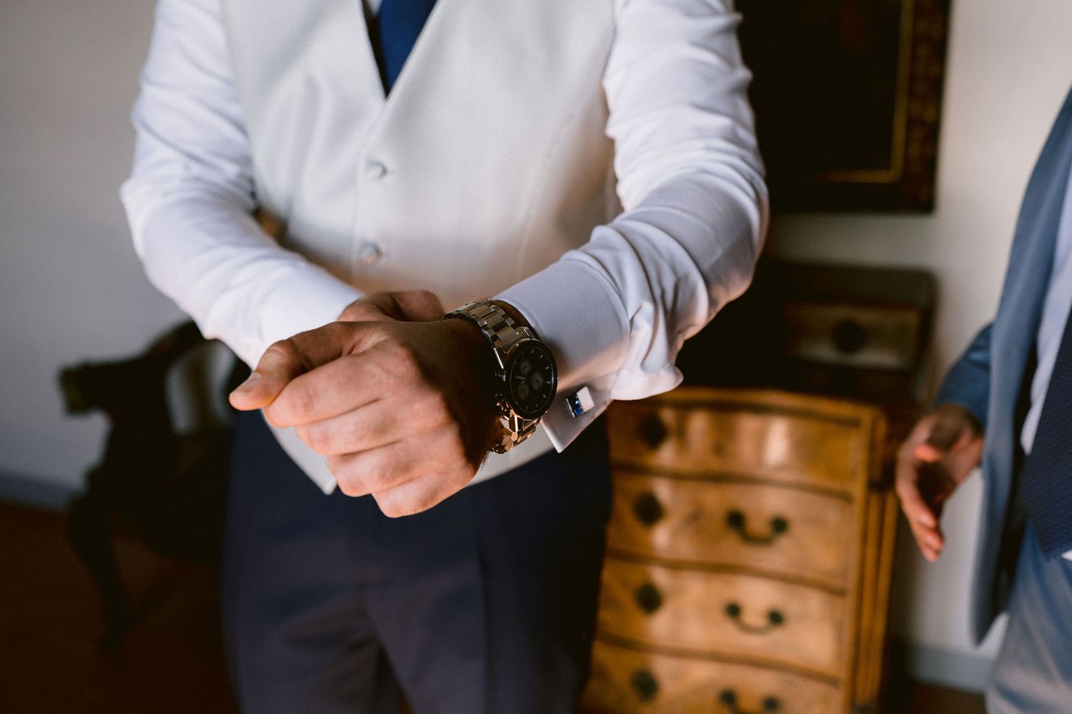 A classic navy suit with blue tie and white shirt is shown in detail through various close-up photos.