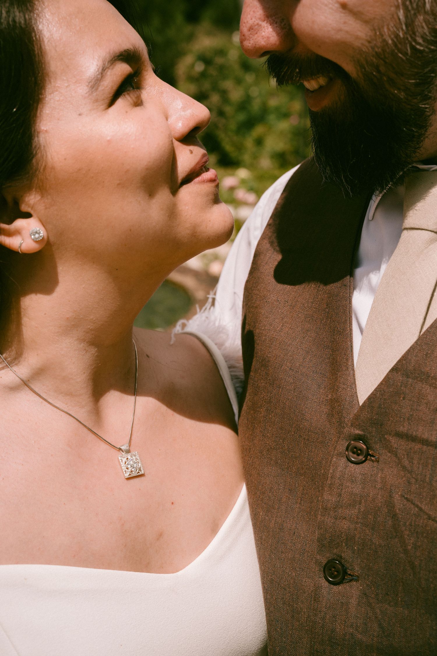 A close-up intimate moment between a couple wearing formal attire.