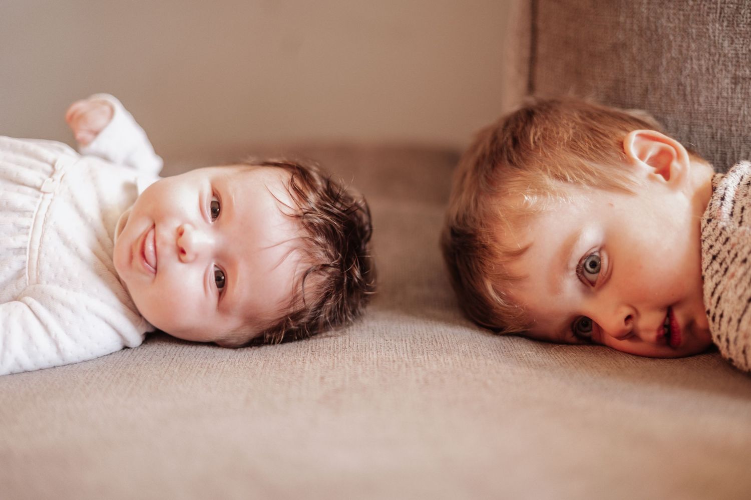 A collage of six photos showing a child lying down and looking at the camera in different poses.