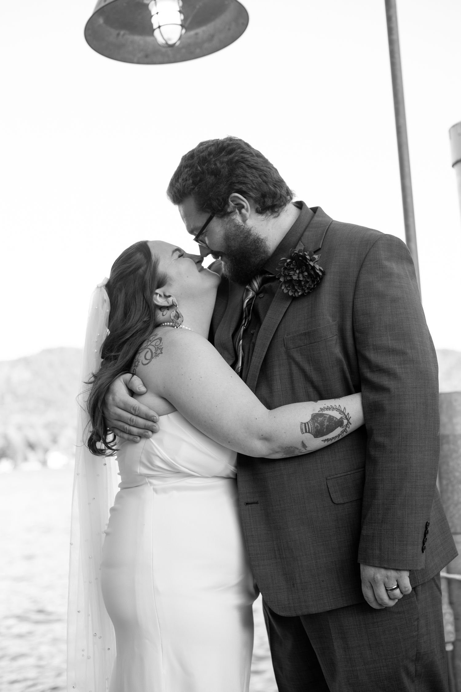 A tender black and white portrait of newlyweds sharing an intimate moment.