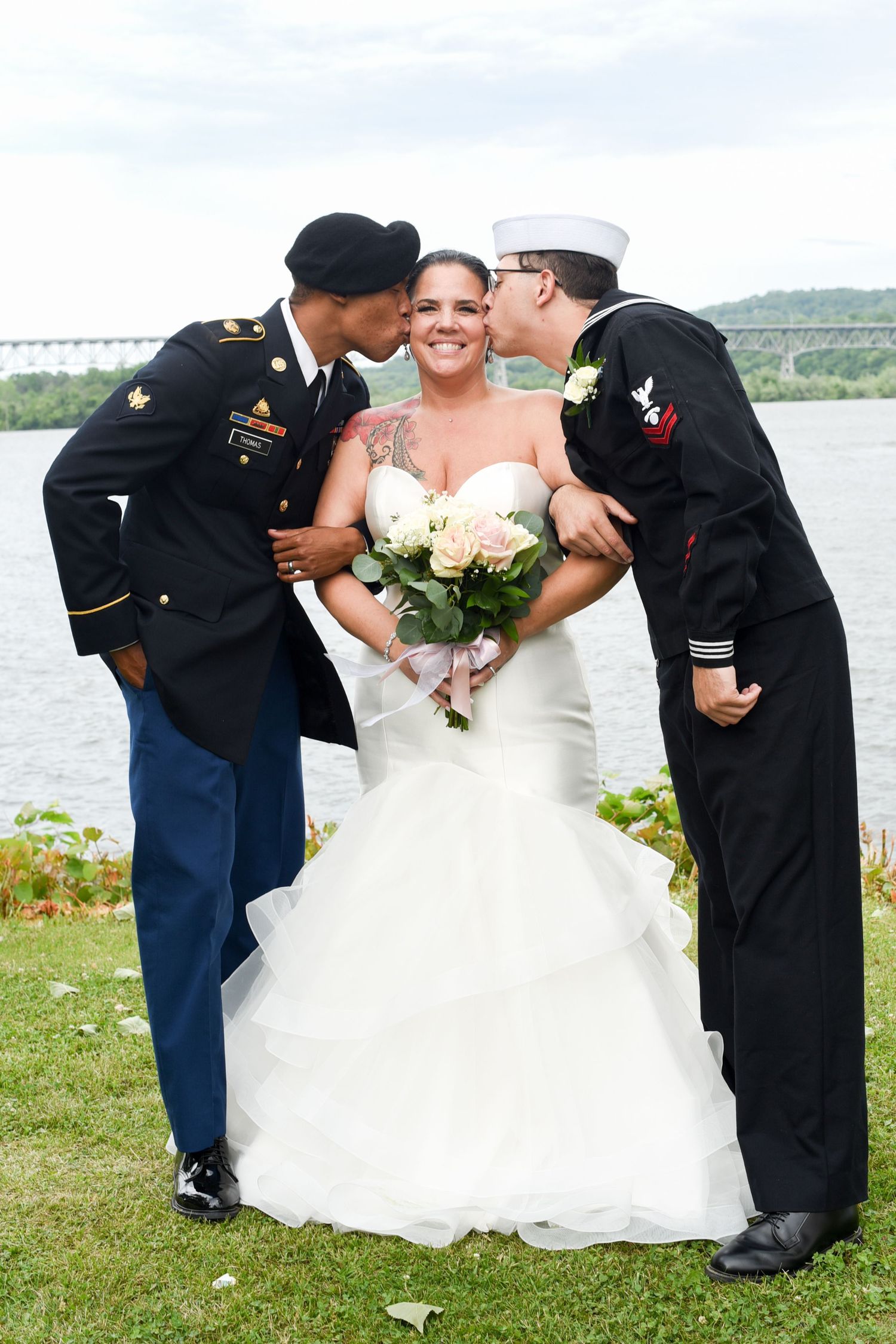 Military servicemen in dress uniforms bow to bride in white gown during wedding ceremony.