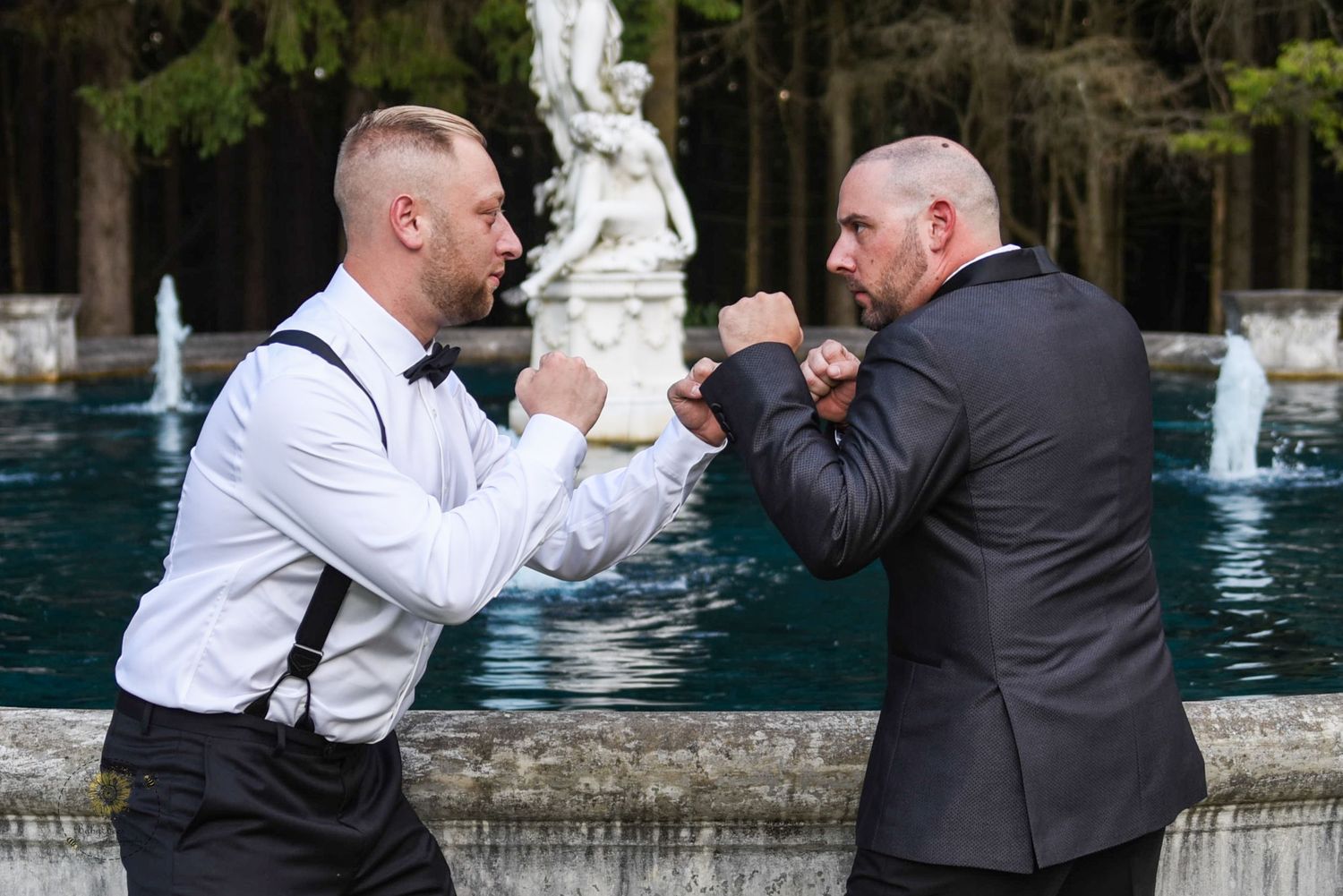 Two people in formal attire playfully pose near a fountain in a series of black and white photos.