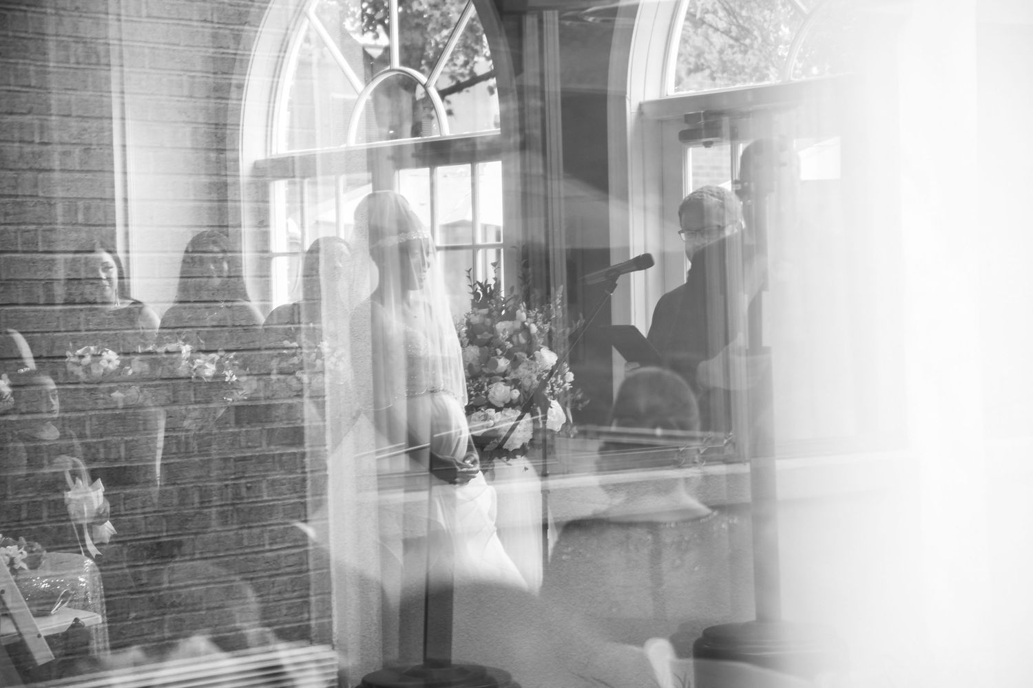 Artistic black and white interior photograph through window panes with soft focus effects.