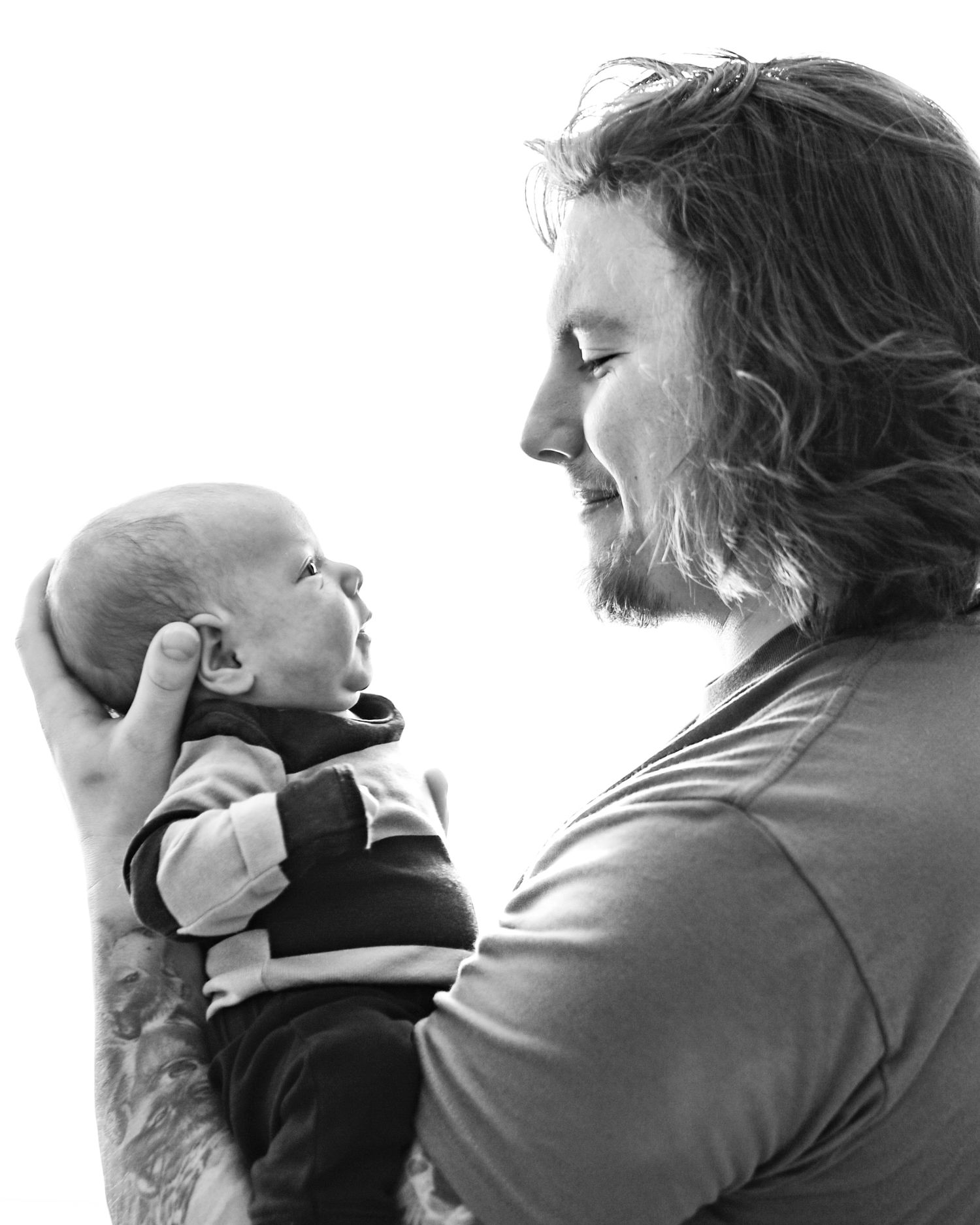A sequence of black and white photographs showing two people in an emotional embrace with dramatic lighting.