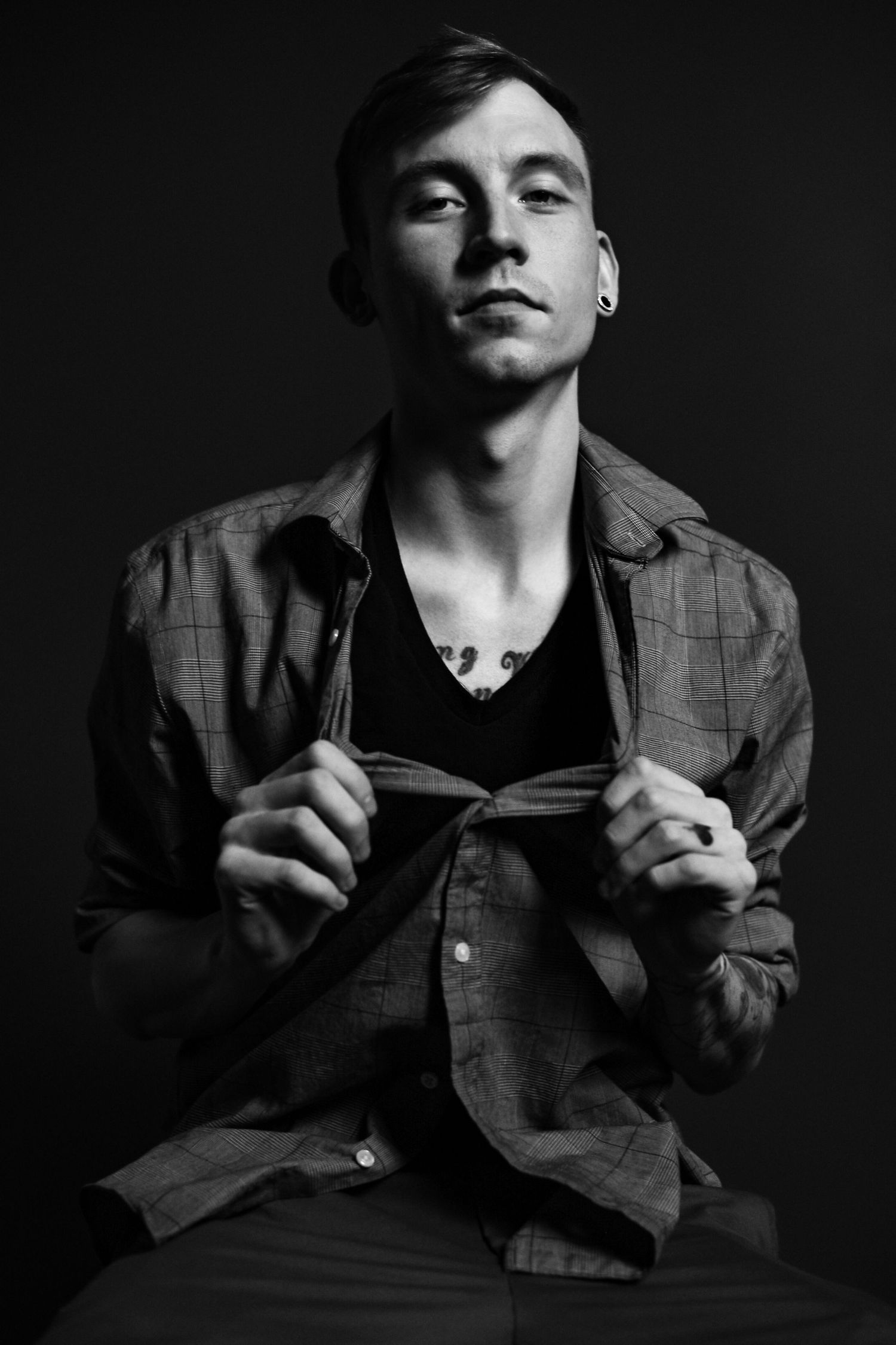 Dramatic black and white portrait series showing expressive poses against dark background.