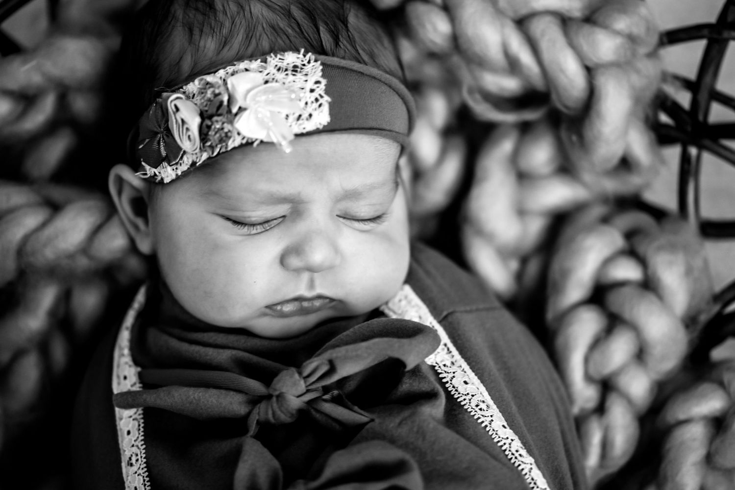 Black and white photo sequence showing a sleeping baby in different positions and expressions.