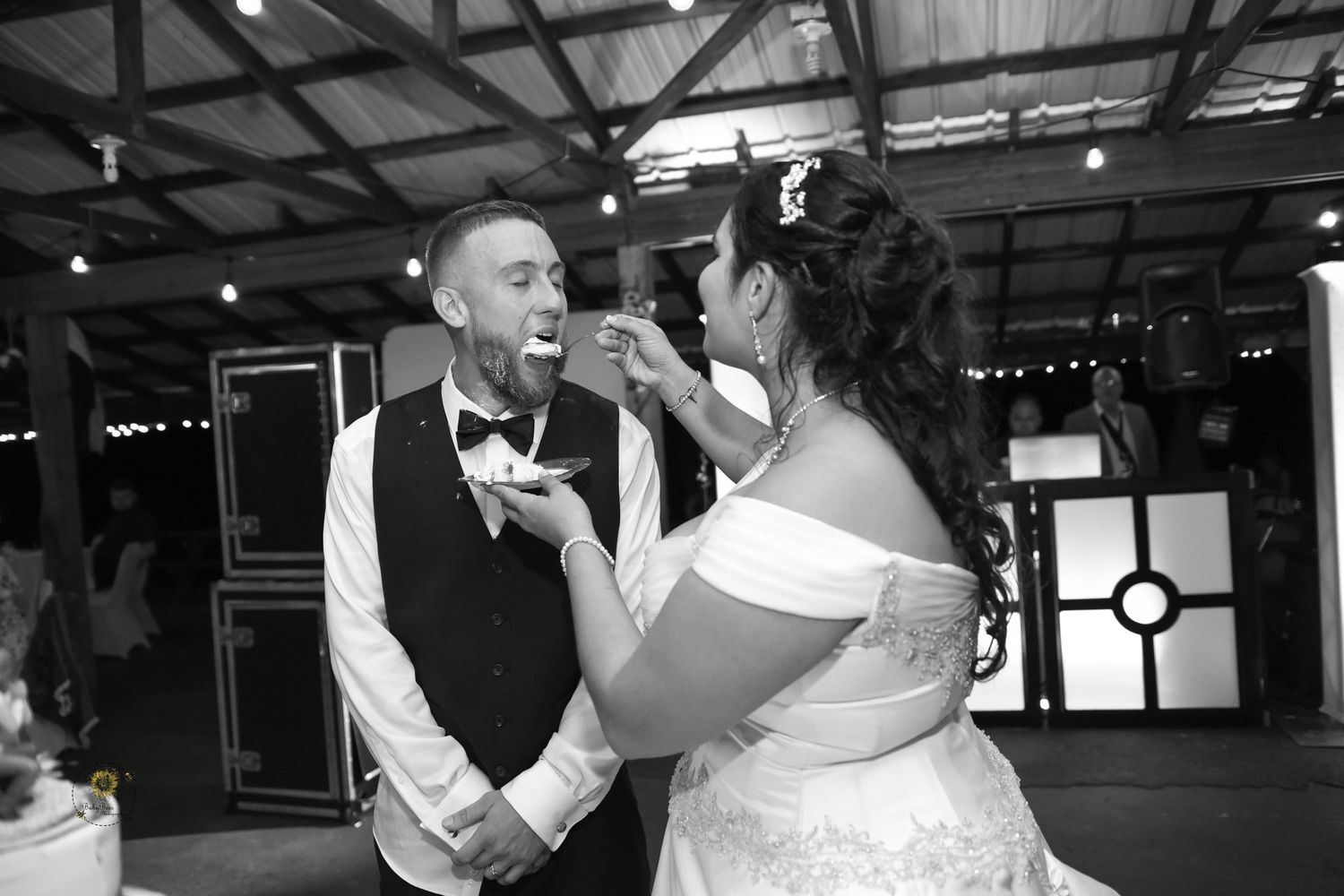 Black and white photos of wedding reception dancing in rustic venue.