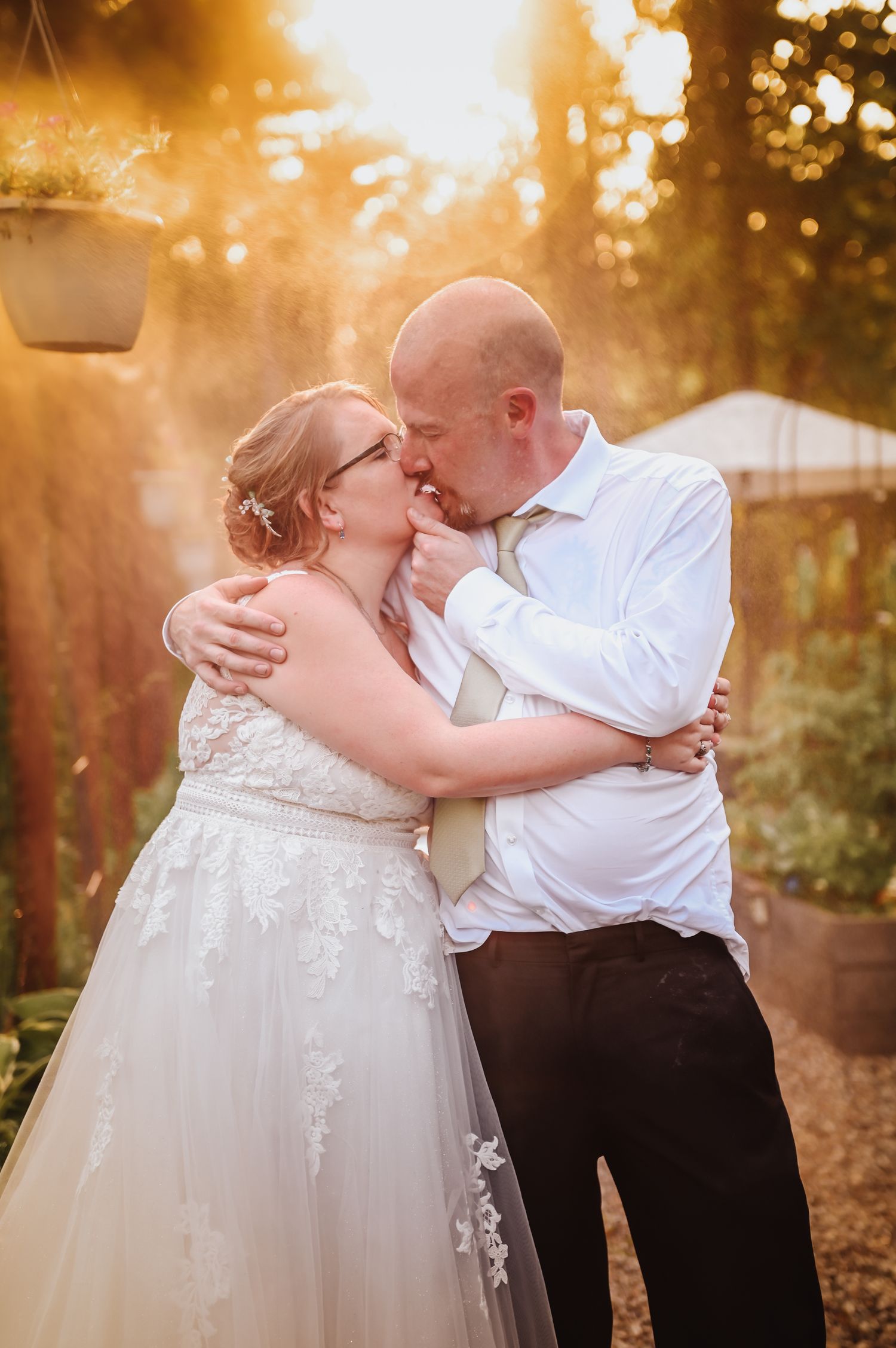 Romantic sunset wedding portraits with golden light filtering through trees.