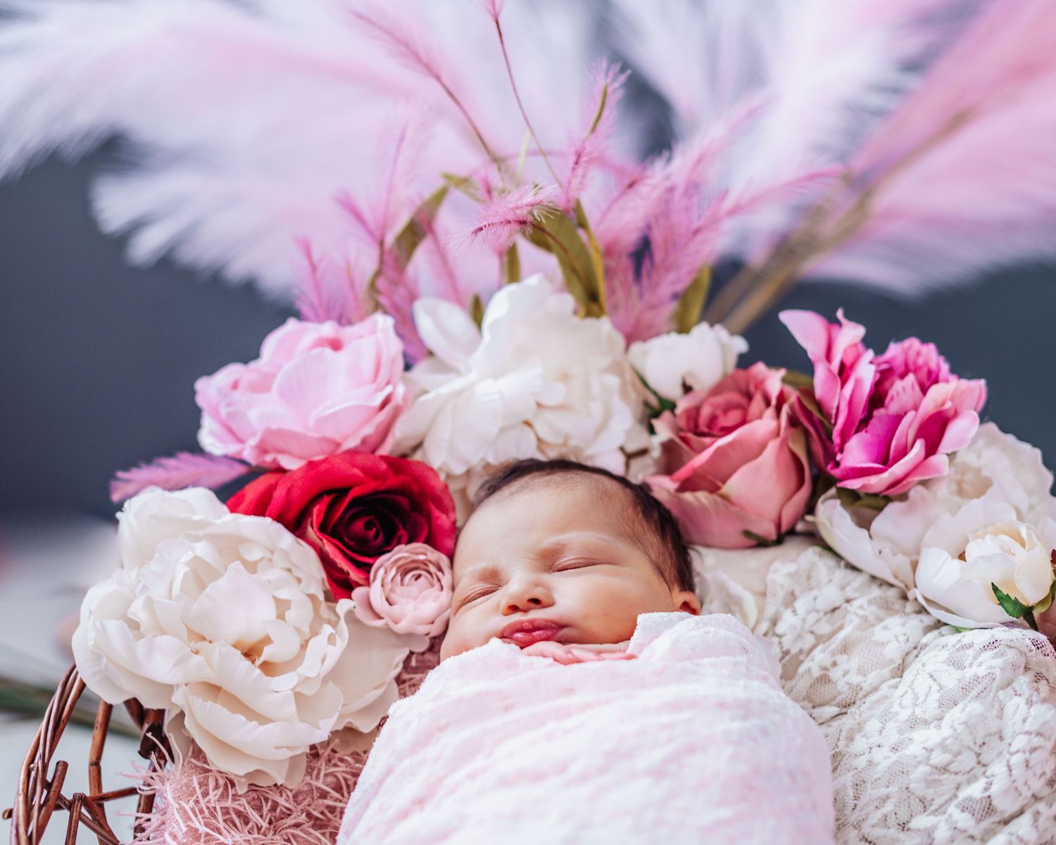 A delicate arrangement of pink and white roses with scattered petals creating a romantic floral backdrop.