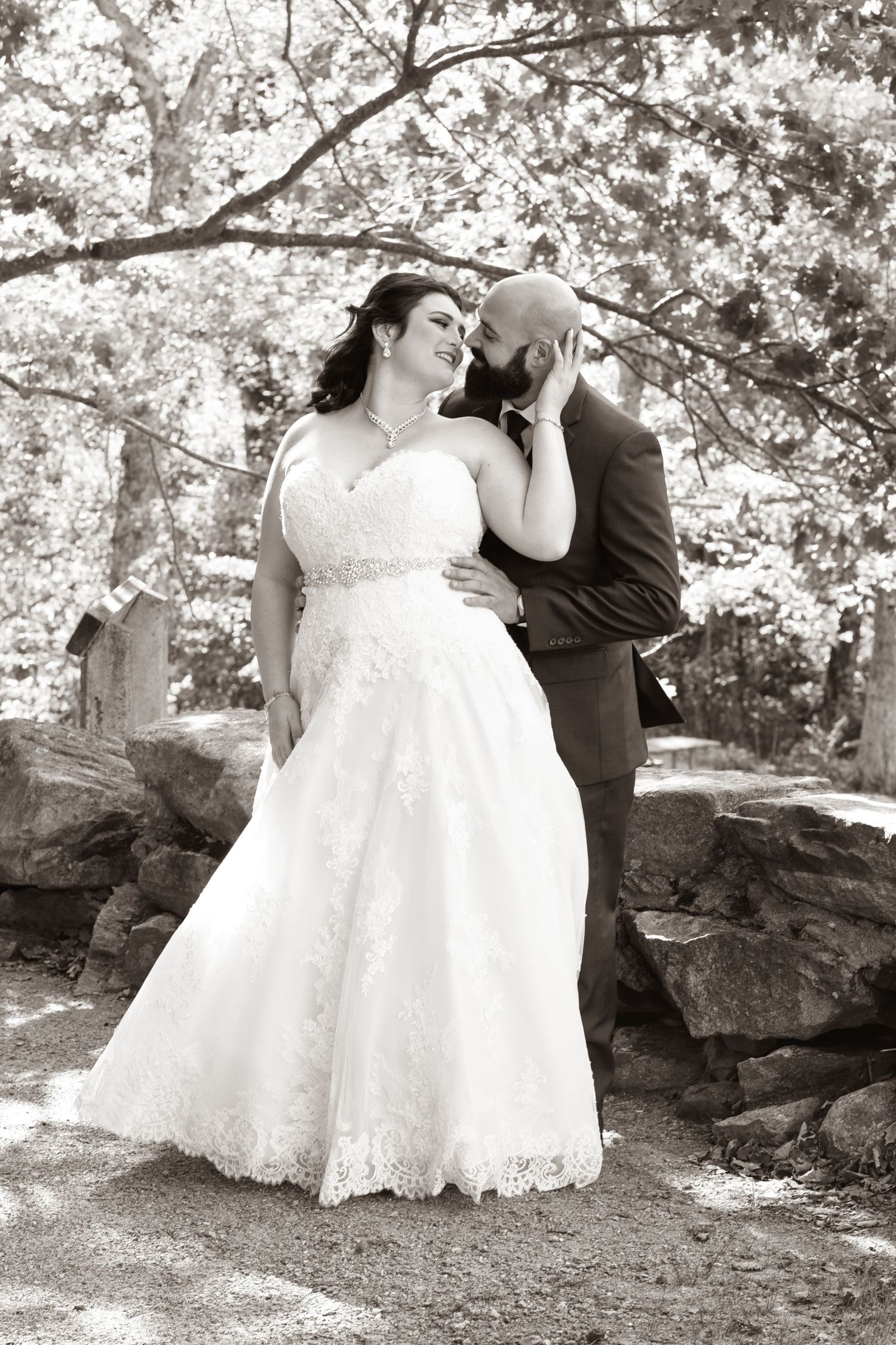 Black and white wedding portraits taken in outdoor garden setting.