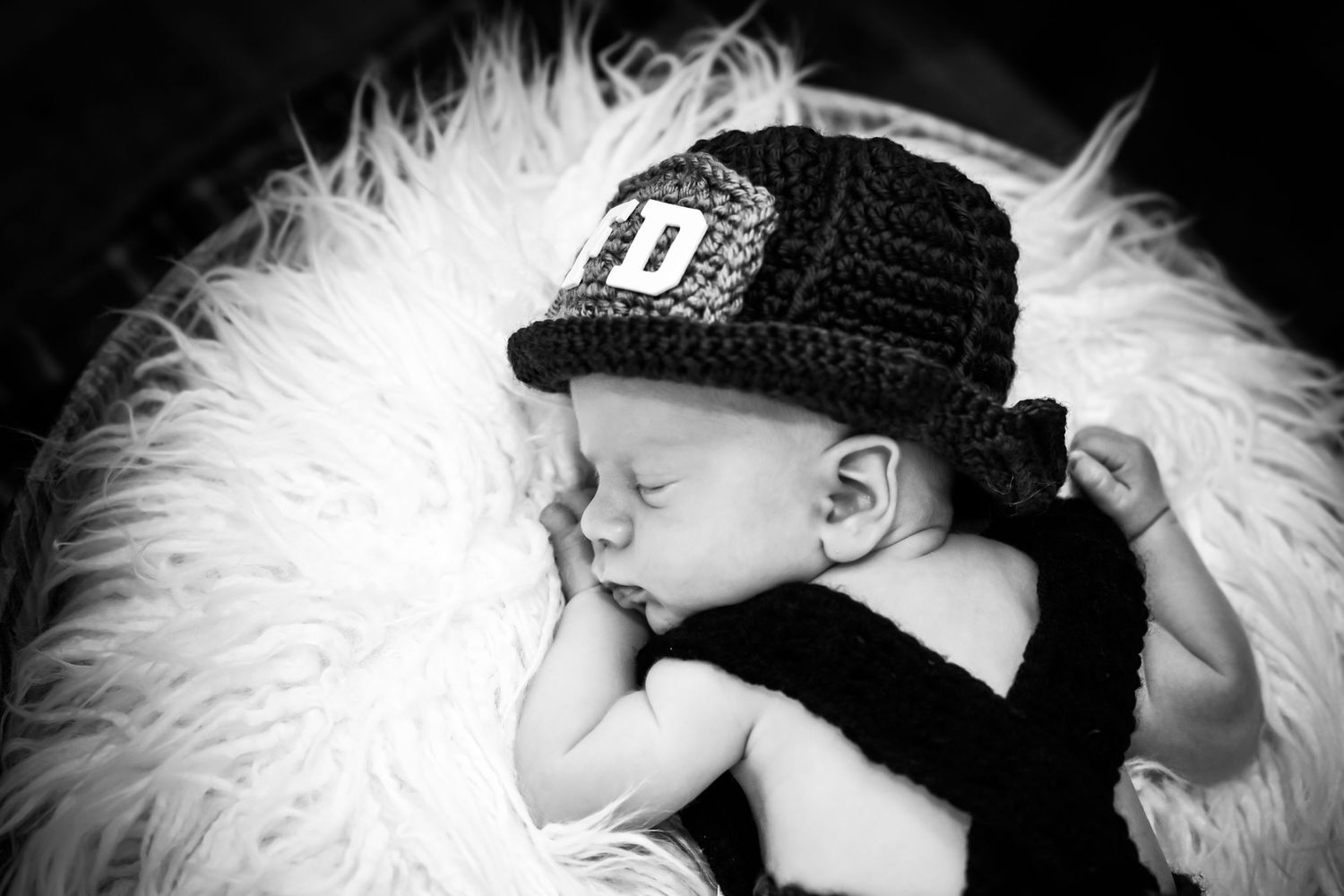 A black and white photo sequence showing a sleeping baby in a baseball cap nestled in white fur.