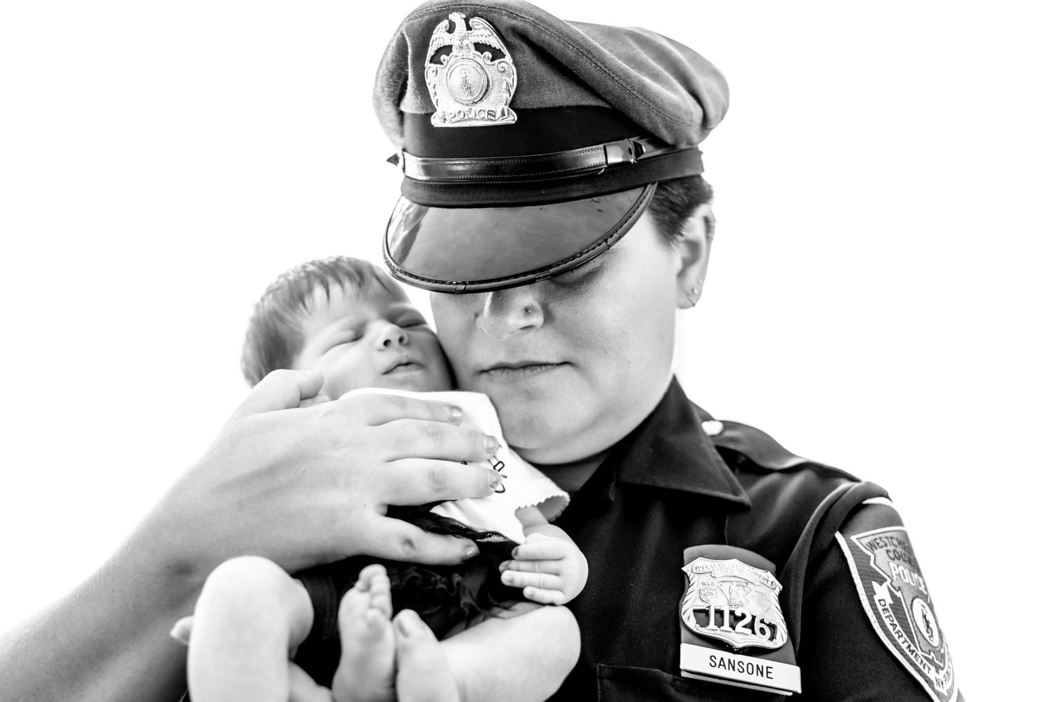Police officers in uniform and protective gear stand in a row during a training or ceremony.