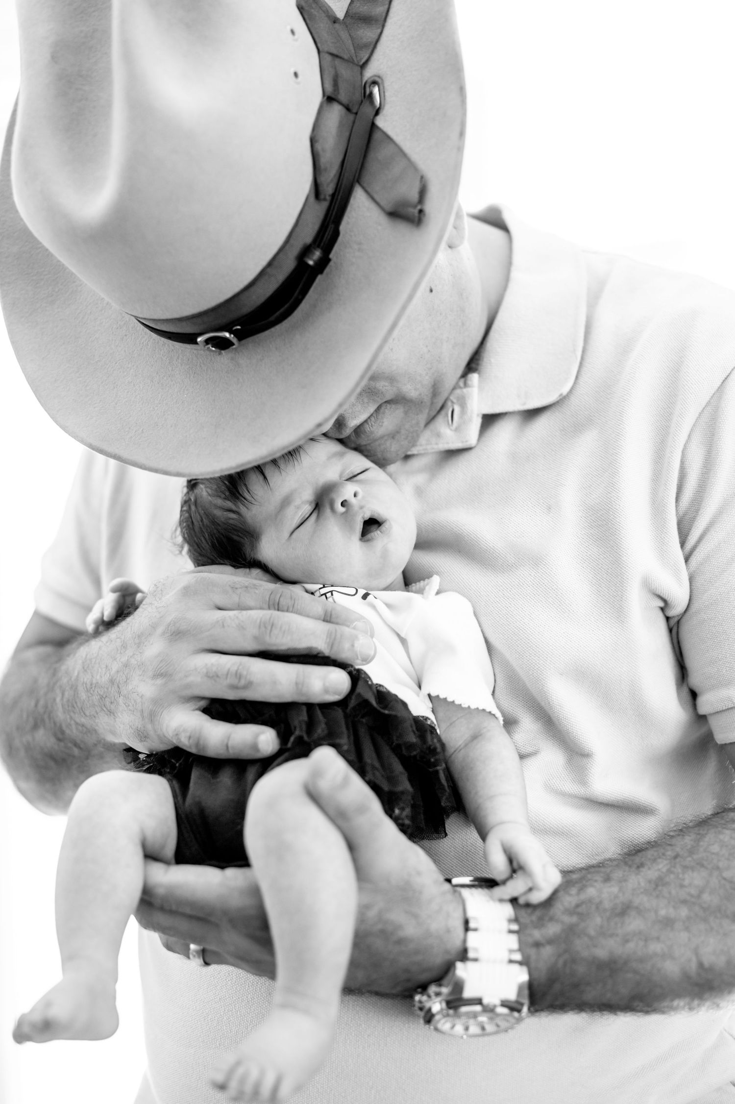 A series of black and white photos showing a person bottle feeding a baby in different positions.