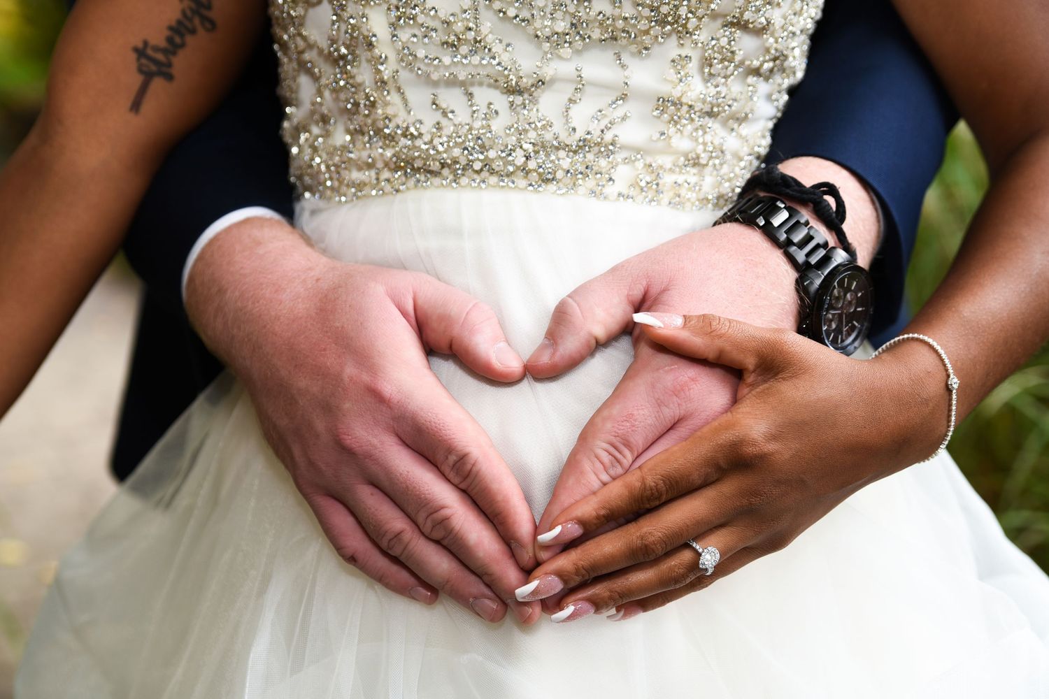 Close-up details of a sparkly beaded wedding dress and rings.