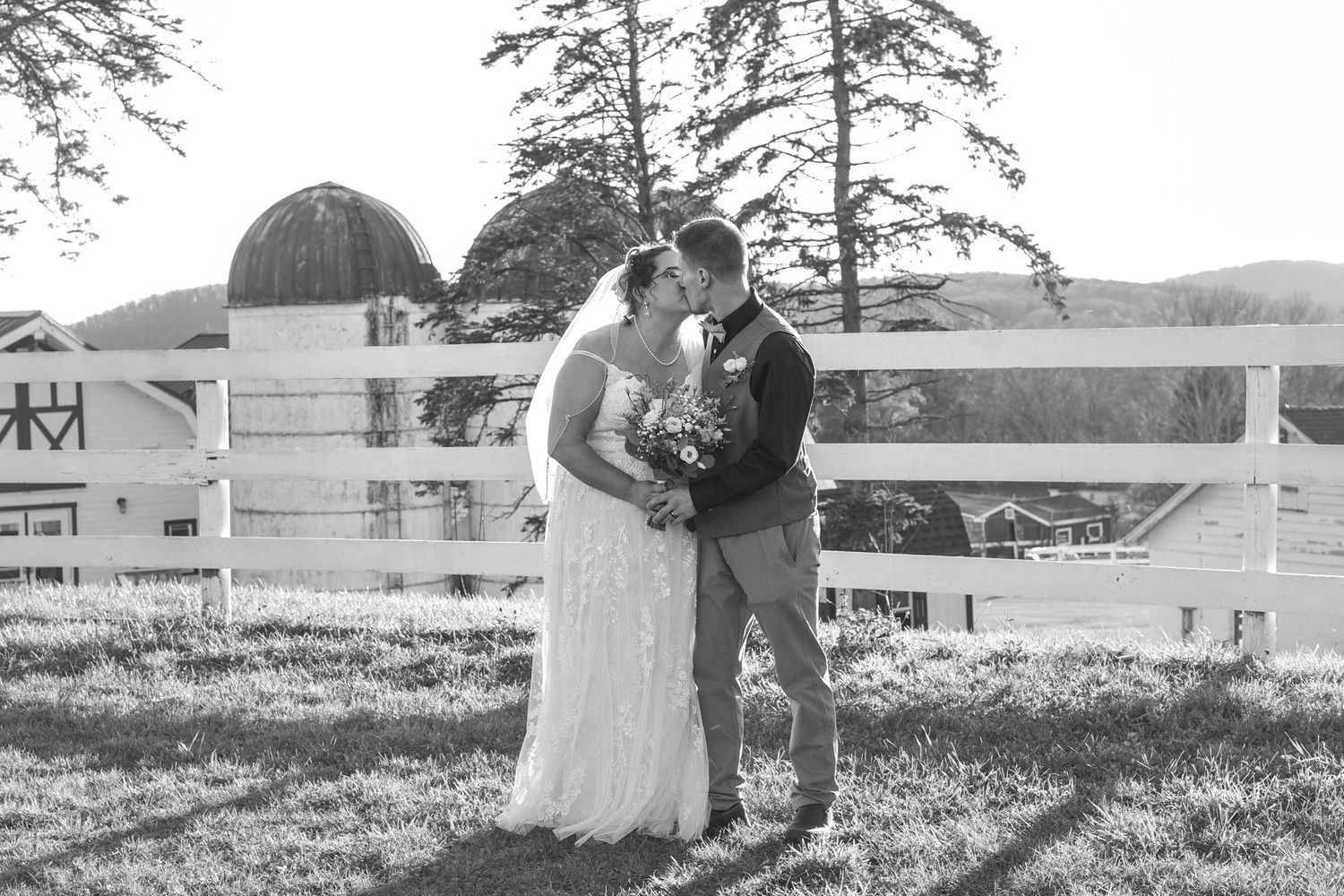 Black and white wedding photos captured in a scenic countryside setting.