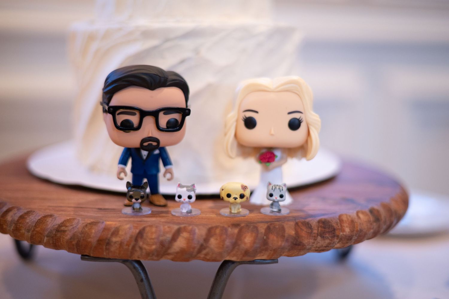 Cute decorative Funko Pop figurines arranged as wedding cake toppers.