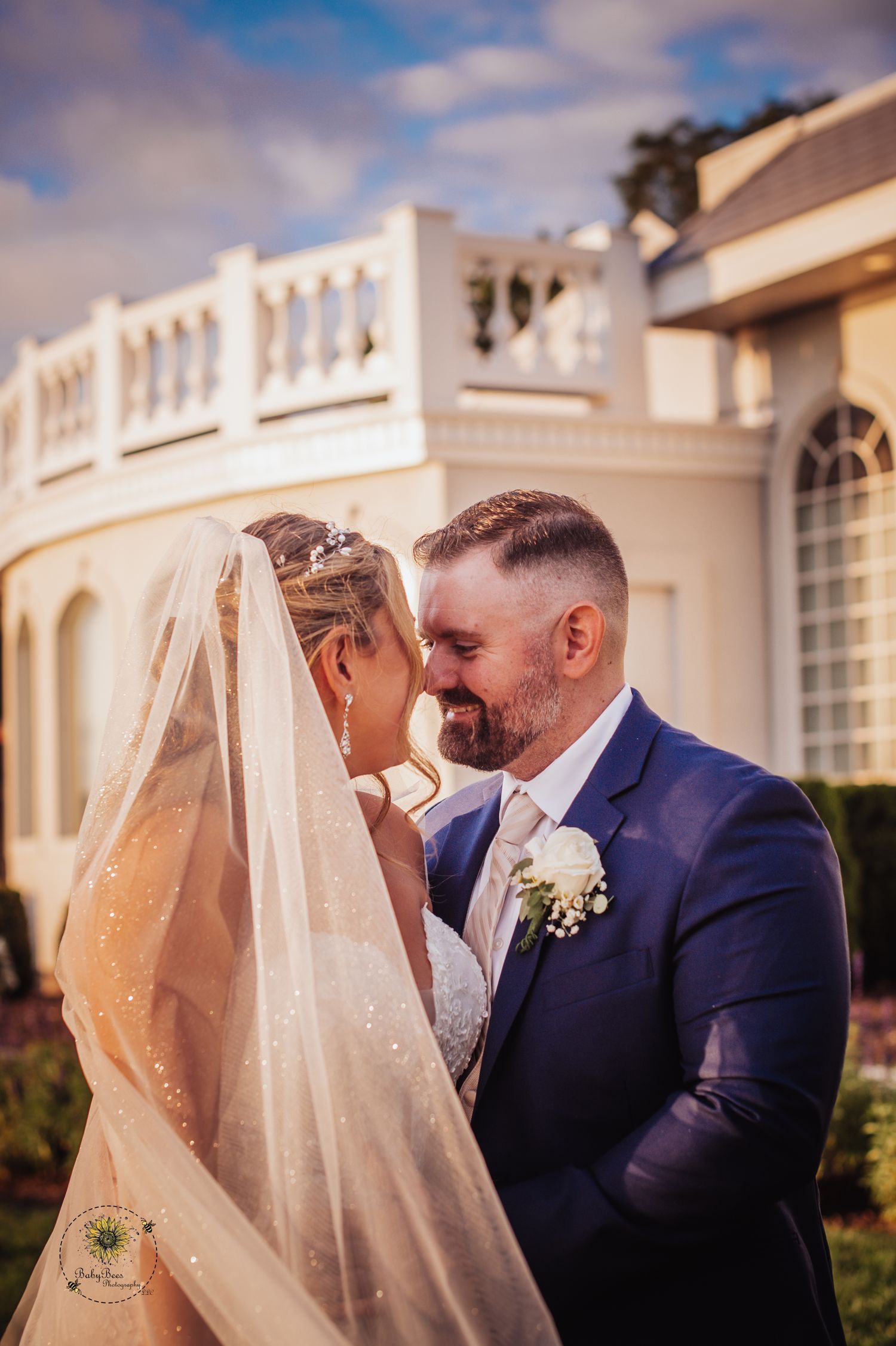 Intimate wedding moments captured outside a white colonial-style building.
