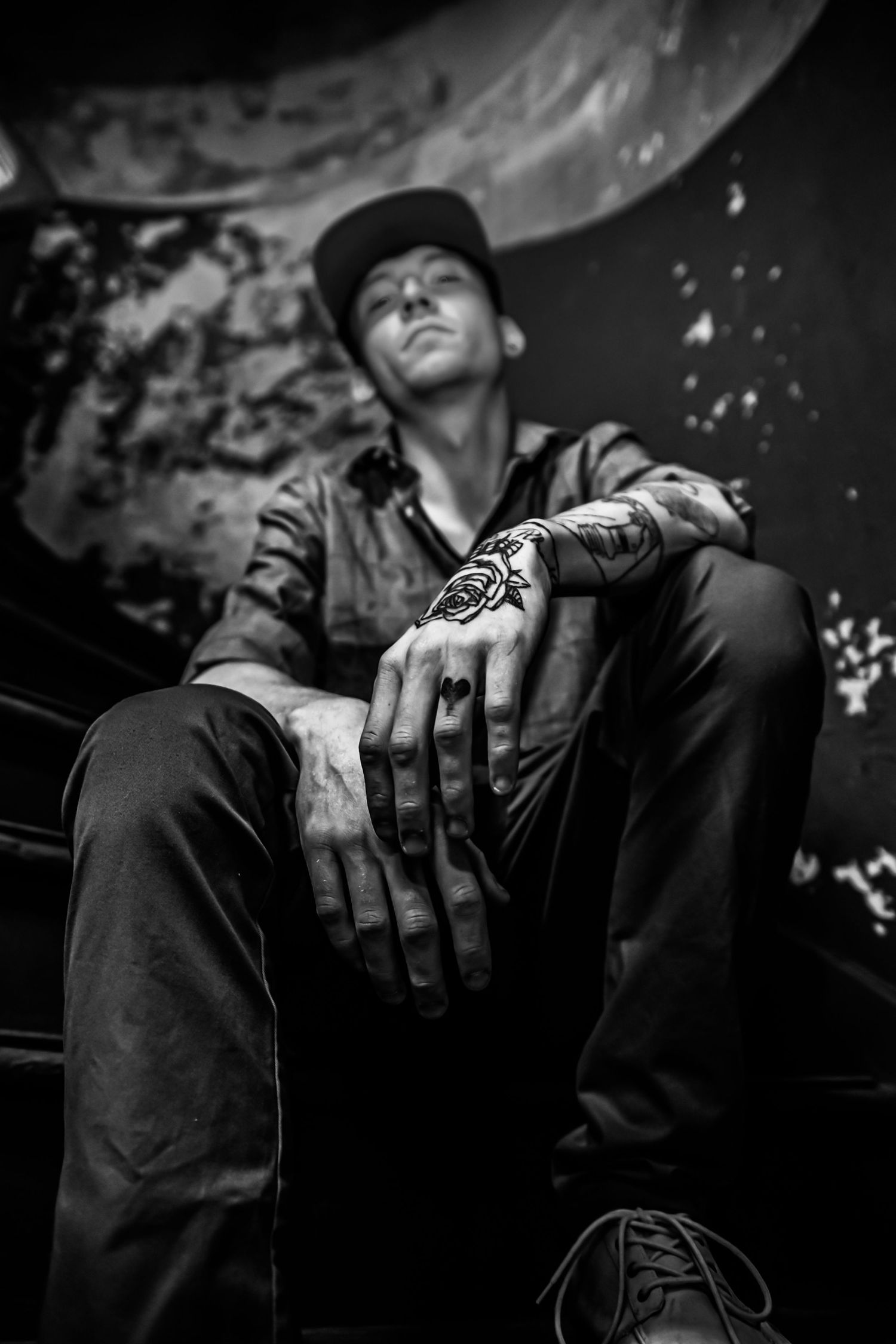 Black and white artistic photo series showing intimate moments of a couple in romantic poses against dark background.