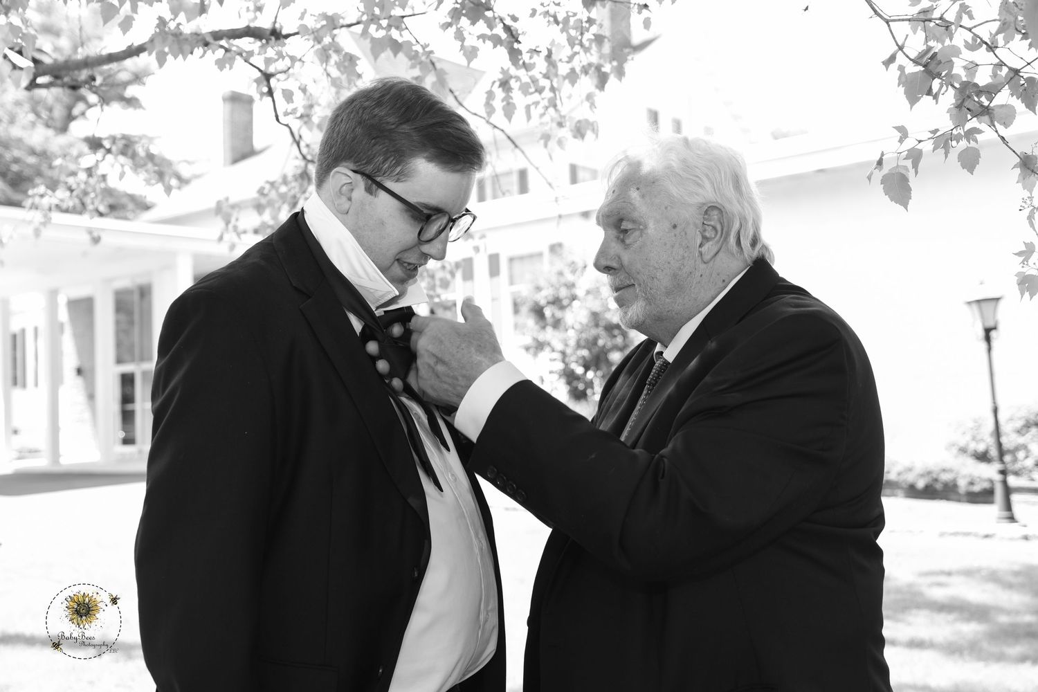 Black and white formal wedding portraits taken outdoors in natural lighting.
