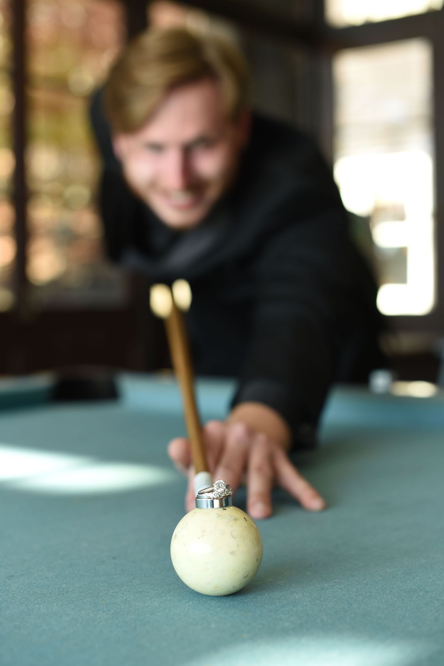 Close-up sequence of a billiards shot on a blue felt table.