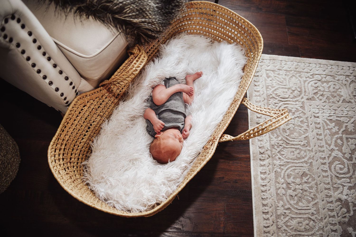 A series of newborn photos showing a baby lying in a woven basket surrounded by soft white fabric and textured backdrops.