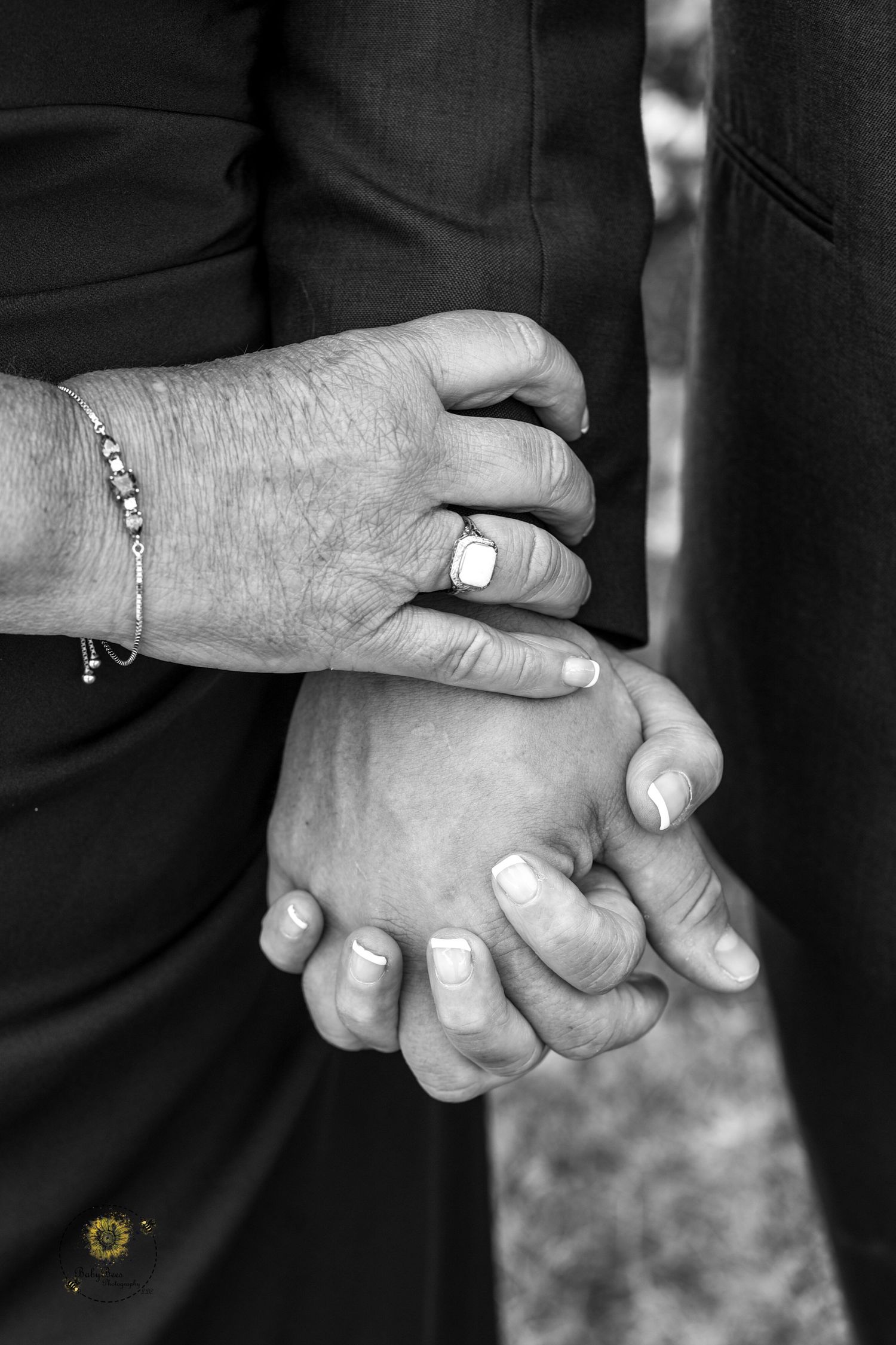 Black and white close-up shots of hands with wedding rings.