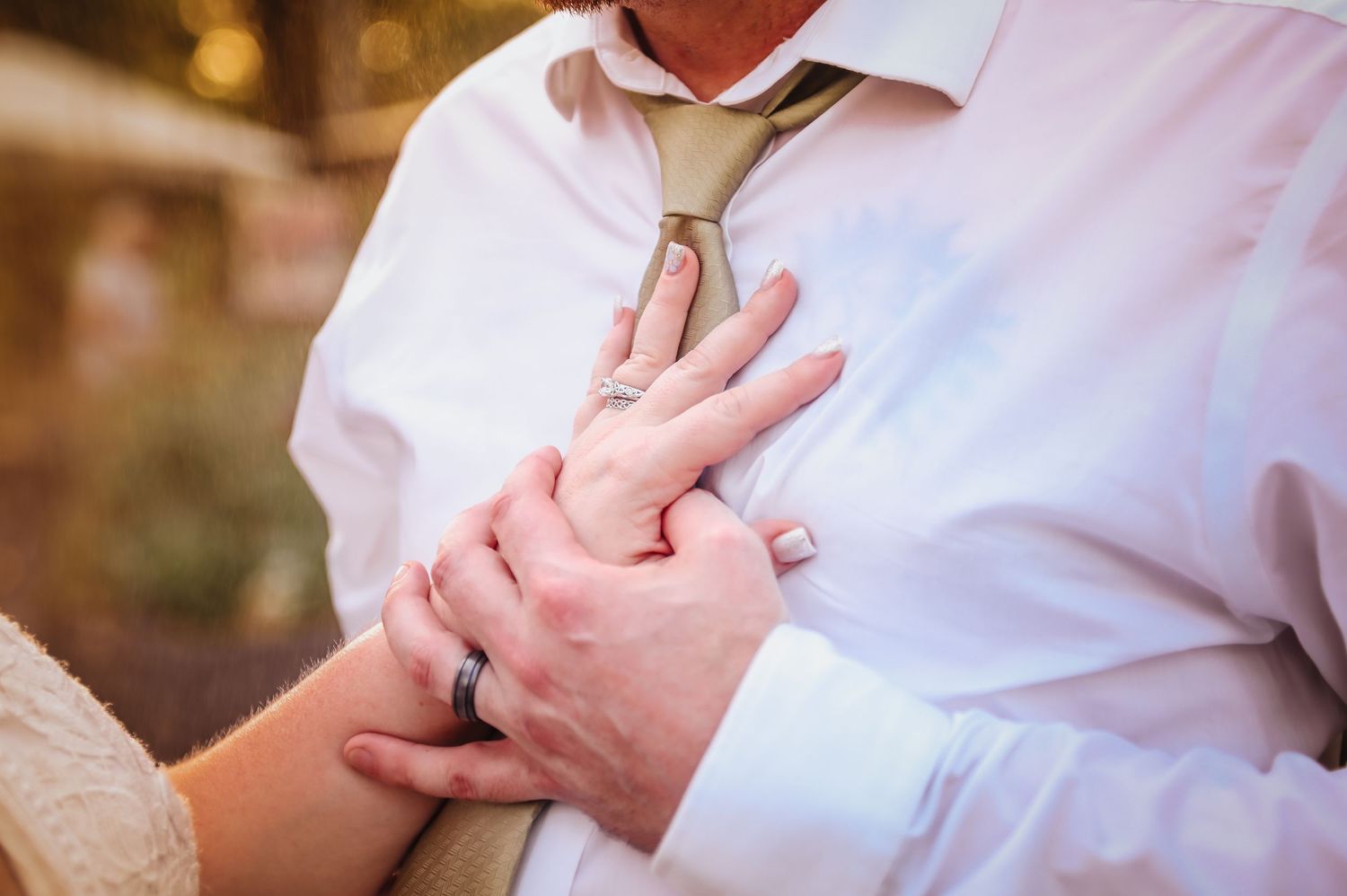 Close-up details of wedding rings and hands during intimate moments.