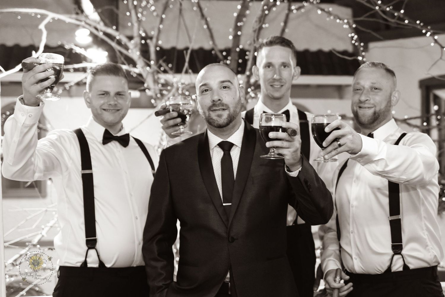 Groomsmen in formal attire posing together at wedding celebration.